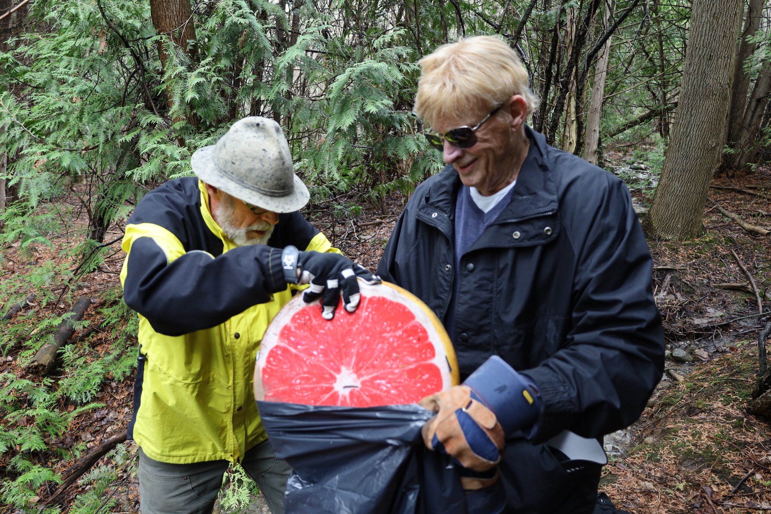 Gunther Schubert (left) and Ken Clare (right) give up their day by cleaning up litter throughout Jackson Park and Jackson Creek Trail on Earth Day held on Saturday. All photos by David Tuan Bui.