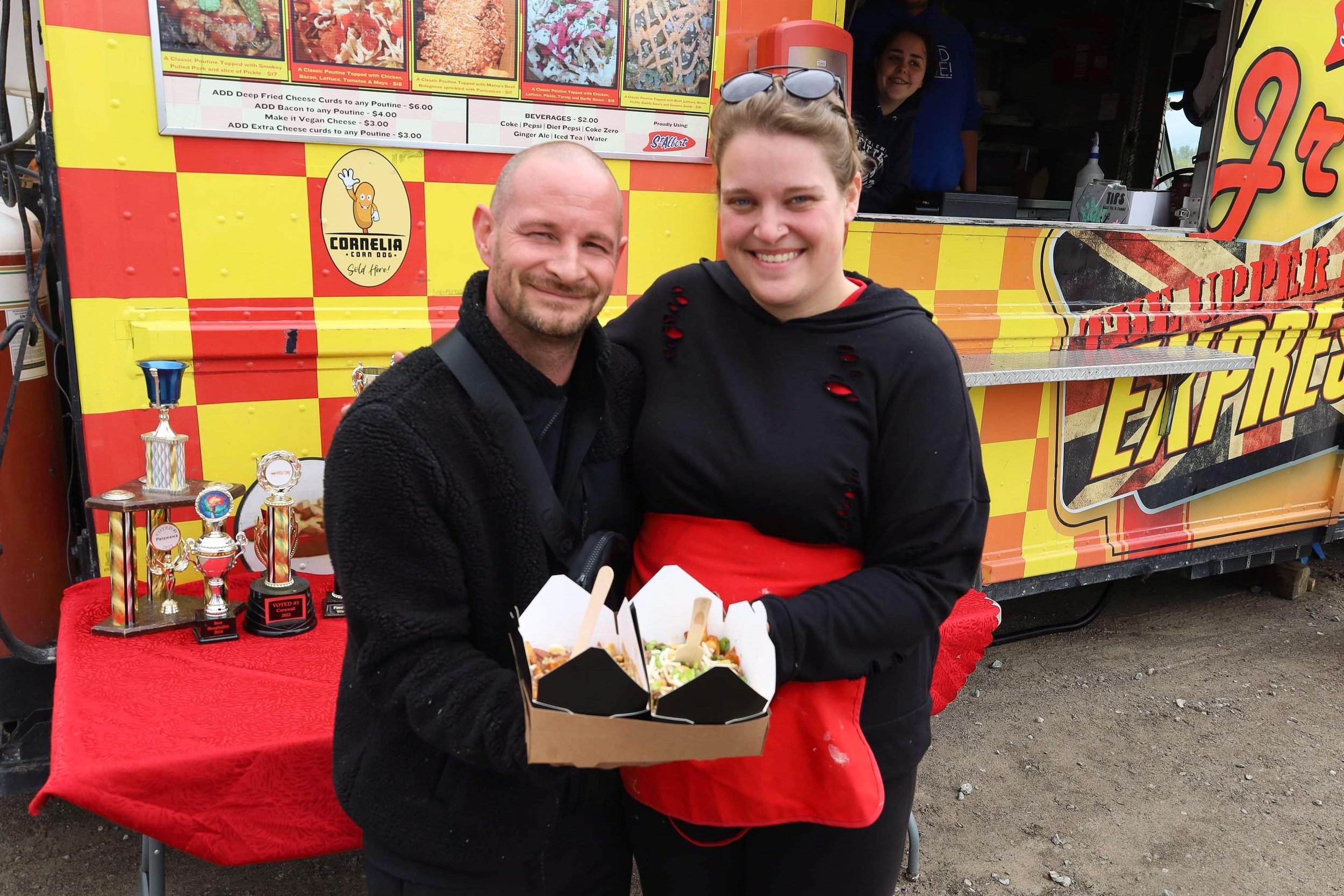  David Conway, Poutine Feast emcee (left) and Bailey McGlennon, Cornelia Corn Dogs operator (right) featuring a classic and award-winning bacon-double cheeseburger poutine as two of over 25 featured kinds at Peterborough Poutine Feast. All photos by 