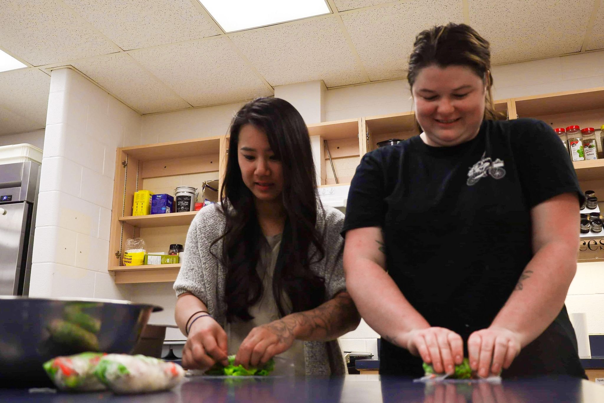 Susan Tung, Hanoi House and NAKA Japanese owner (left) and Morgan Bell, general manager (right) showing HCSS students how to make Vietnamese spring rolls. All photos by Samantha Bianco.