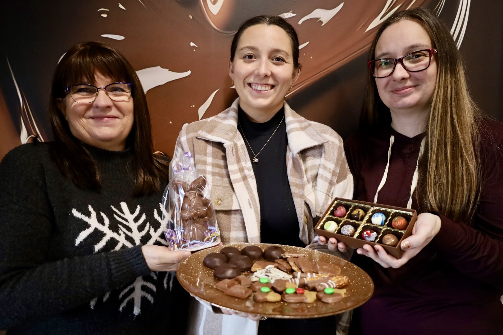 Elaine Webster (left), Kristine Webster (middle) and Nichol Wagenblast (right) showcasing some of the chocolatier's featured items. All photos by David Tuan Bui.