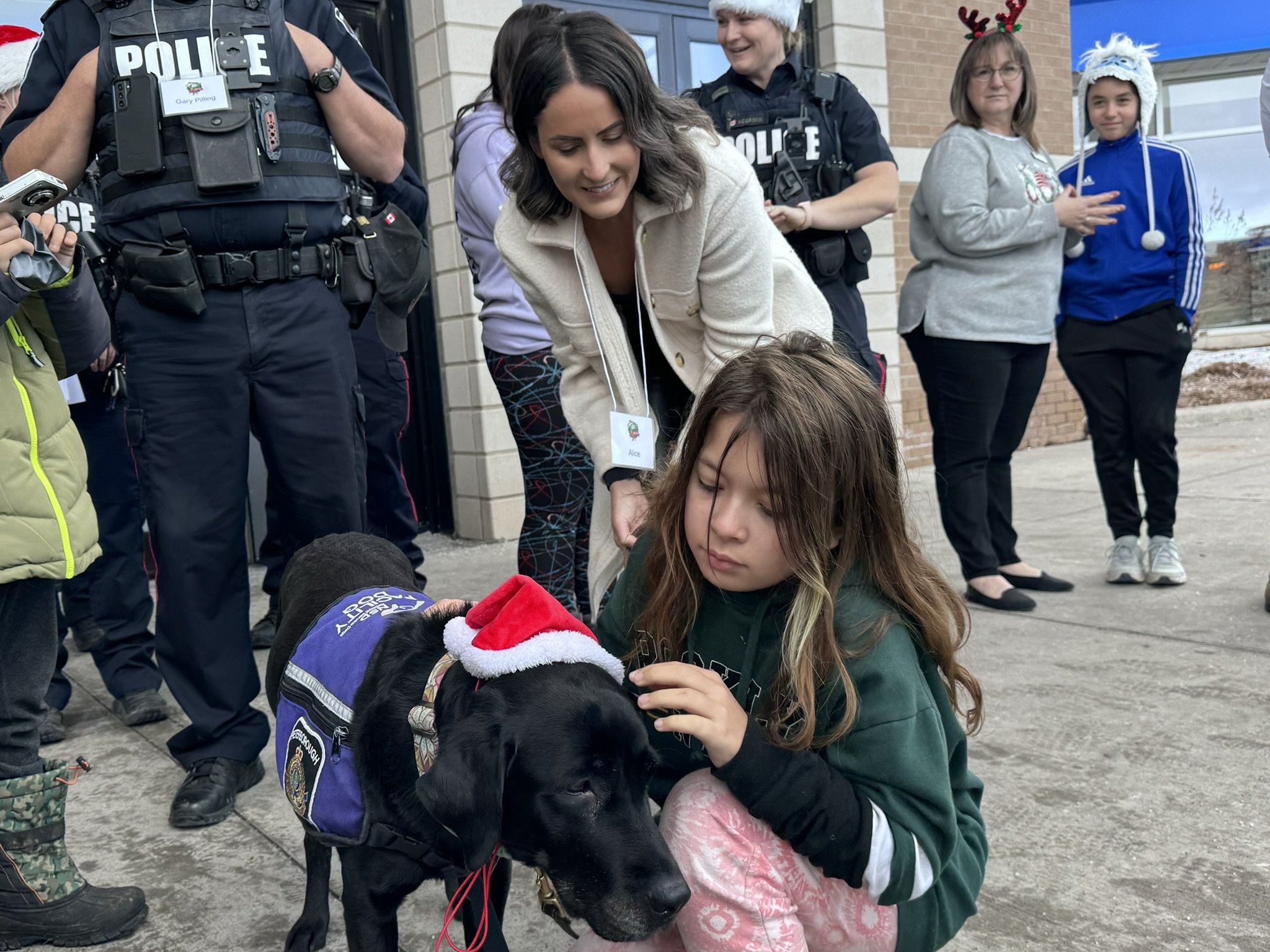 Grade 5 student Josephine Watson, 10, with Alice Czitrom, Peterborough Police Service victim services coordinator and K9 Pixie during the 17th annual CopShop. All photos by David Tuan Bui.