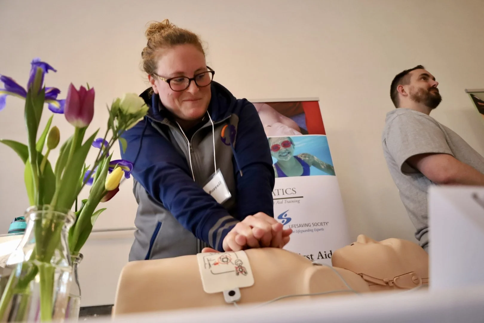Erin Burnell of EB Aquatics demonstrates CPR at the PKED showcase of local business who have gone through their programs. All photos by David Tuan Bui.