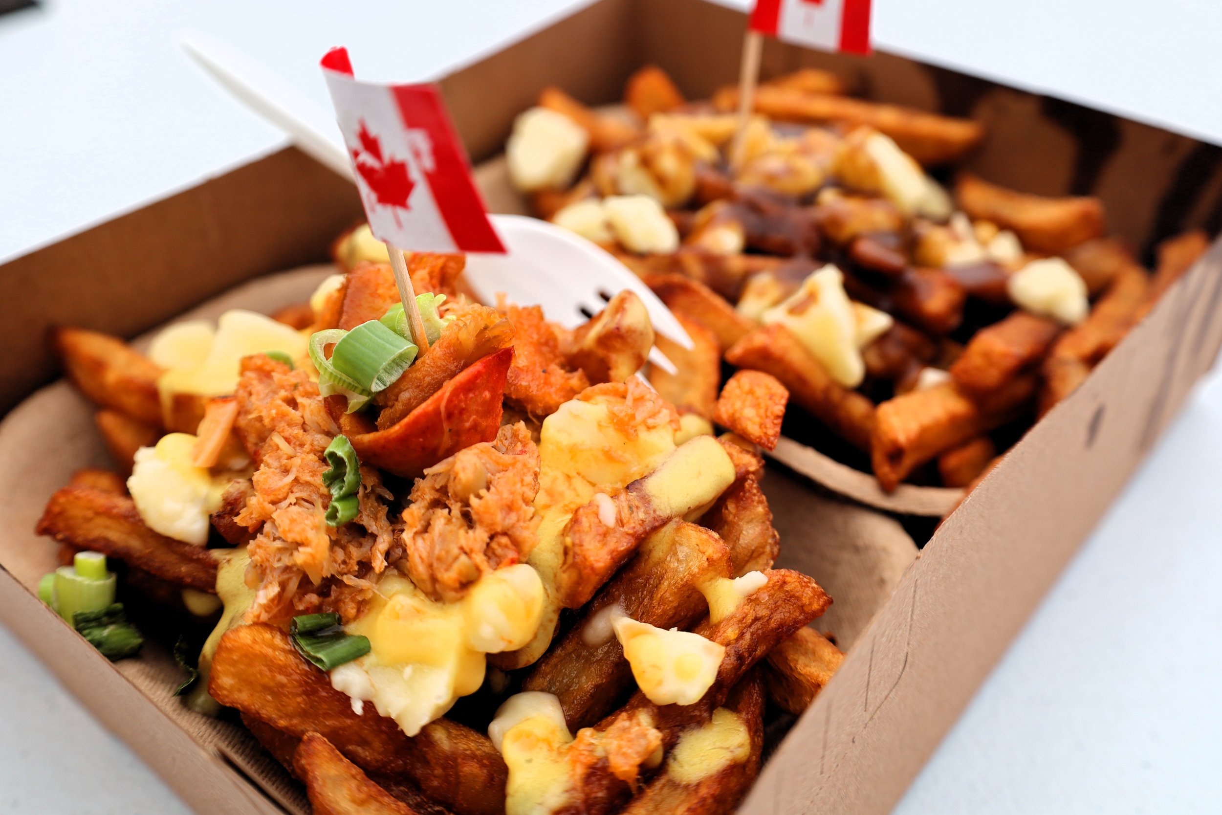 Lobster Poutine (left) and a Classic Poutine from Fat Les's Chip Stand.