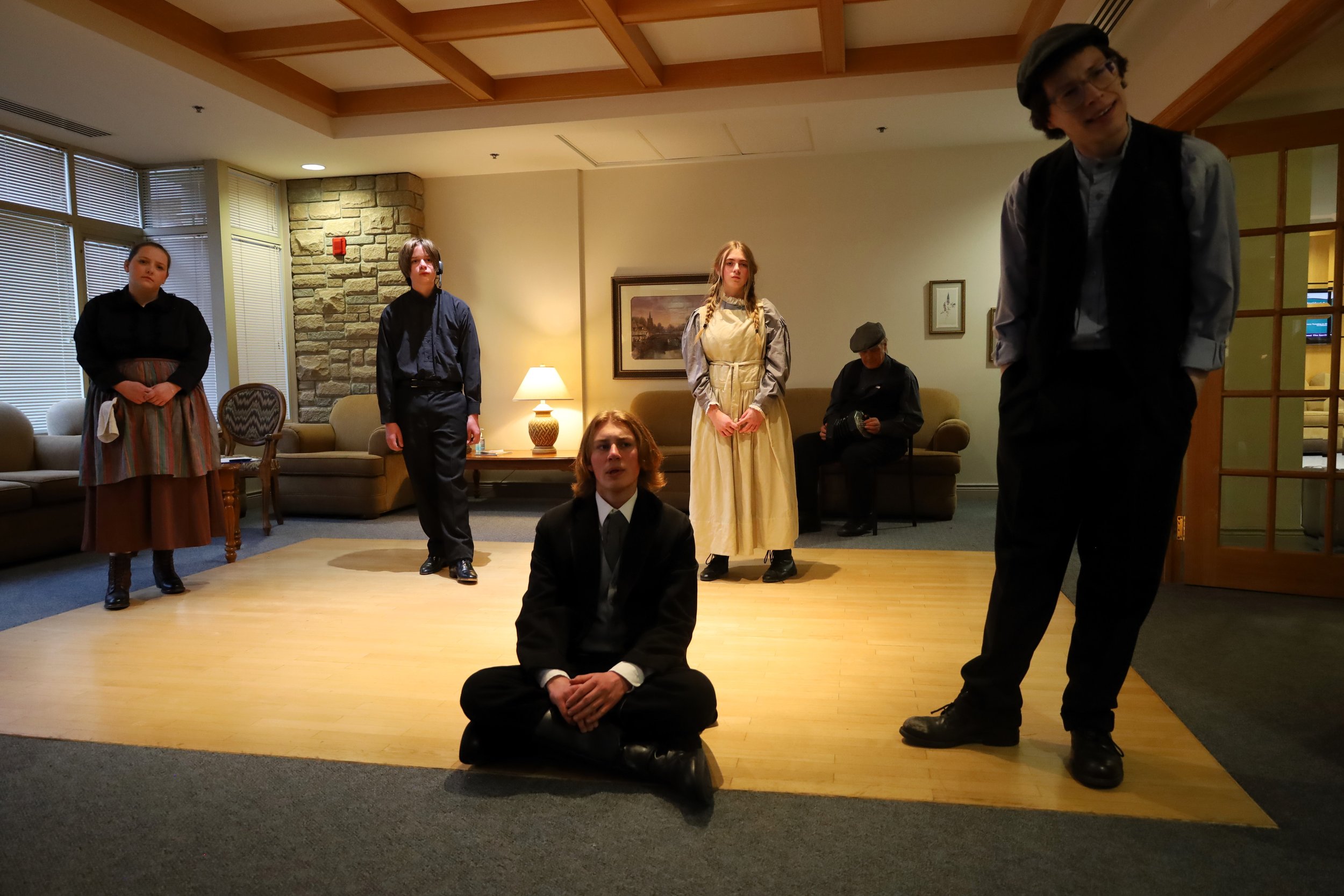 Brogan McKeller (left) as the Stage Manager with the cast members as the production has a play within itself.