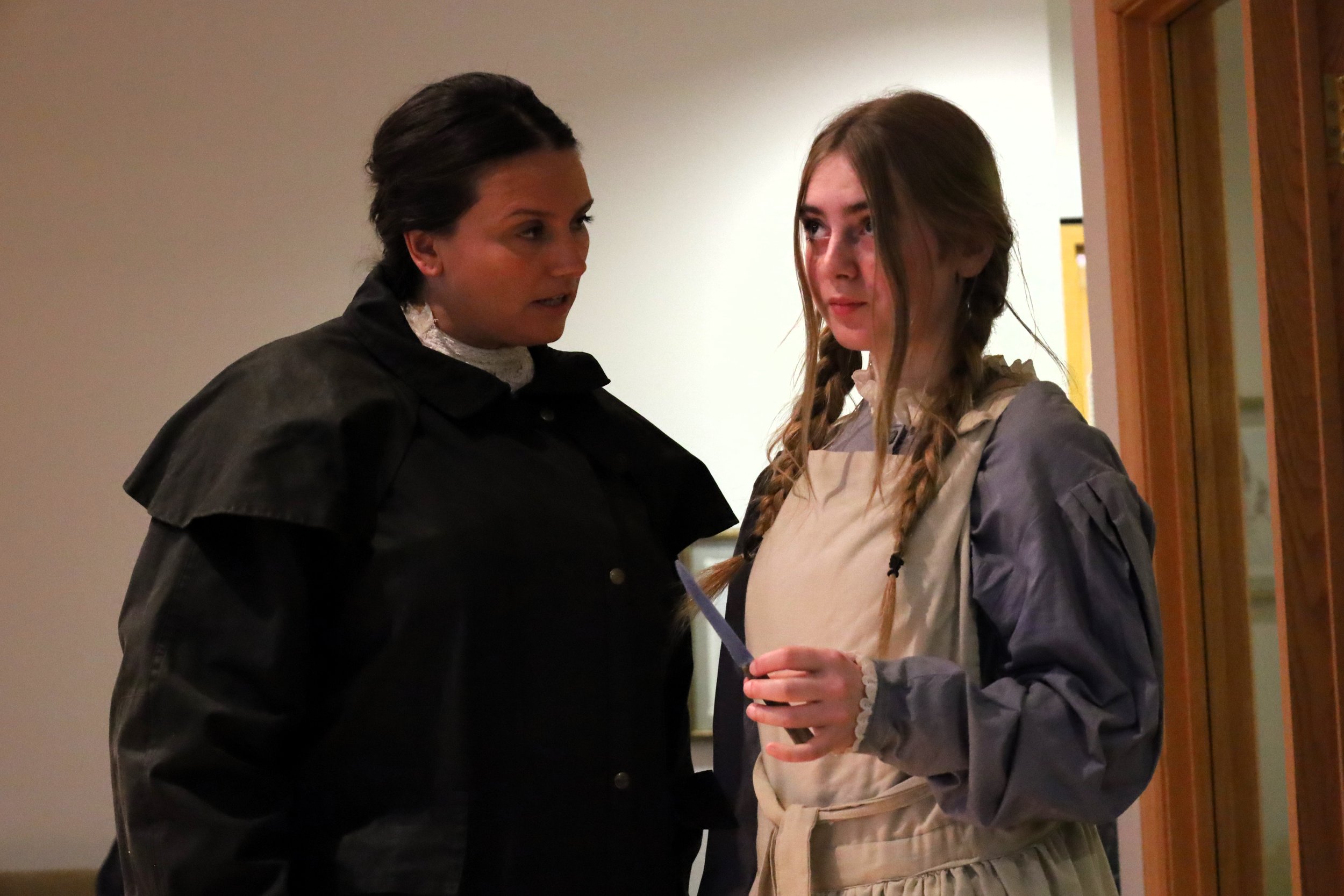 Carling Dulder (left) as Lady Margaret/Midnight as Govier receives a knife from her.