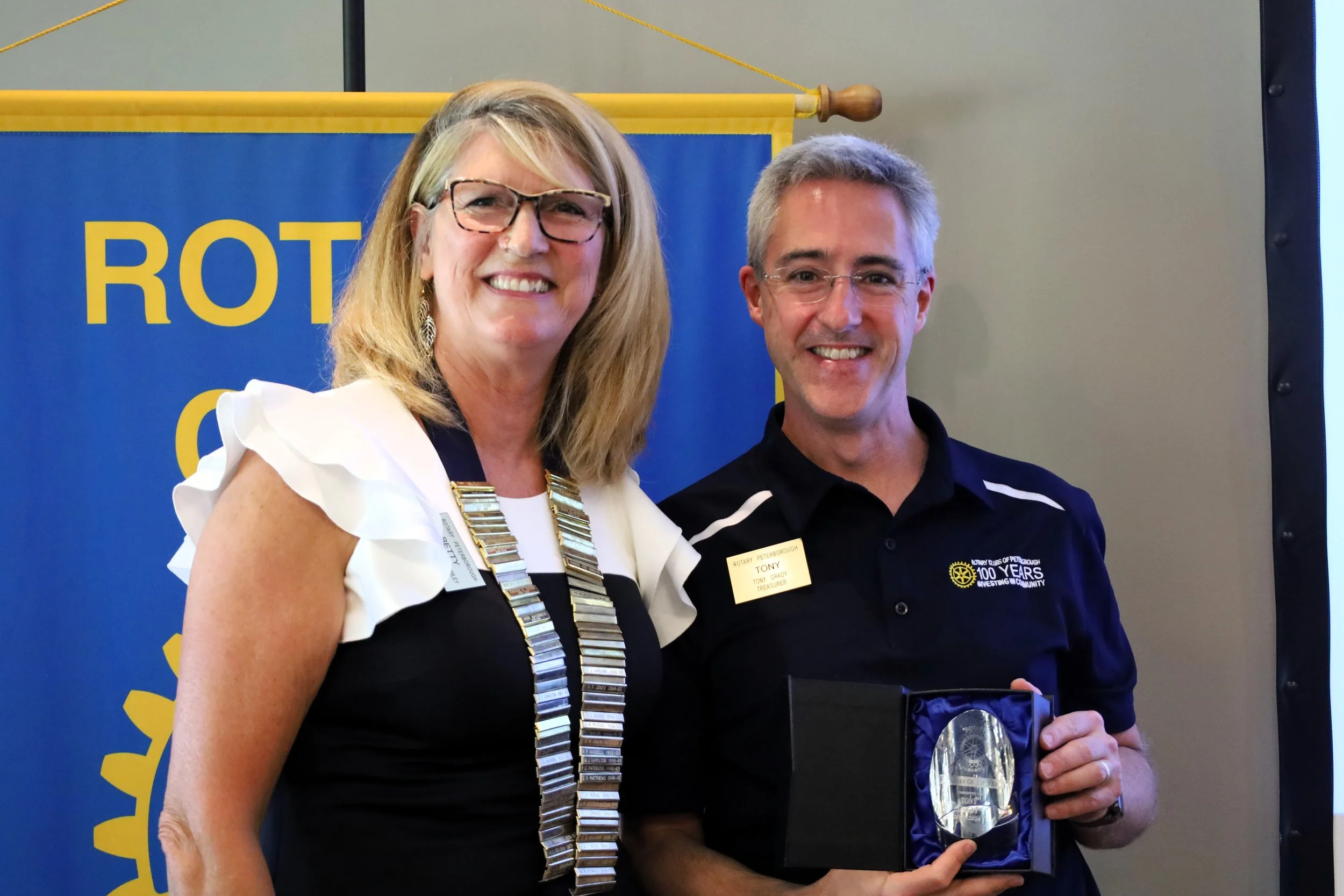 Betty Halman-Plumley honours Tony Grady, Rotary treasurer as one of two Rotarians of the year.