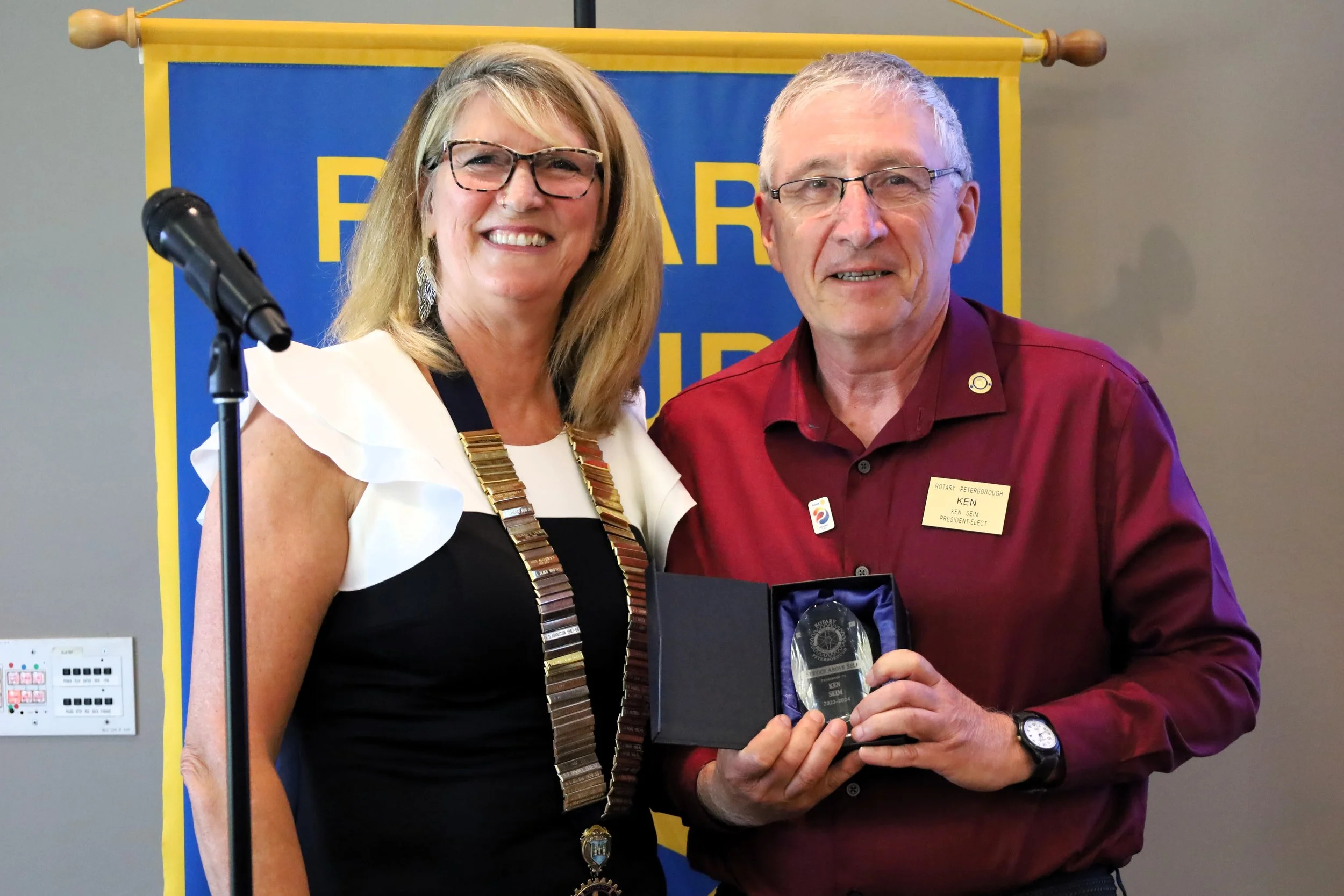 Betty Halman-Plumley, Rotary outgoing president (left) passing the torch to new president Ken Seim. All photos by David Tuan Bui.