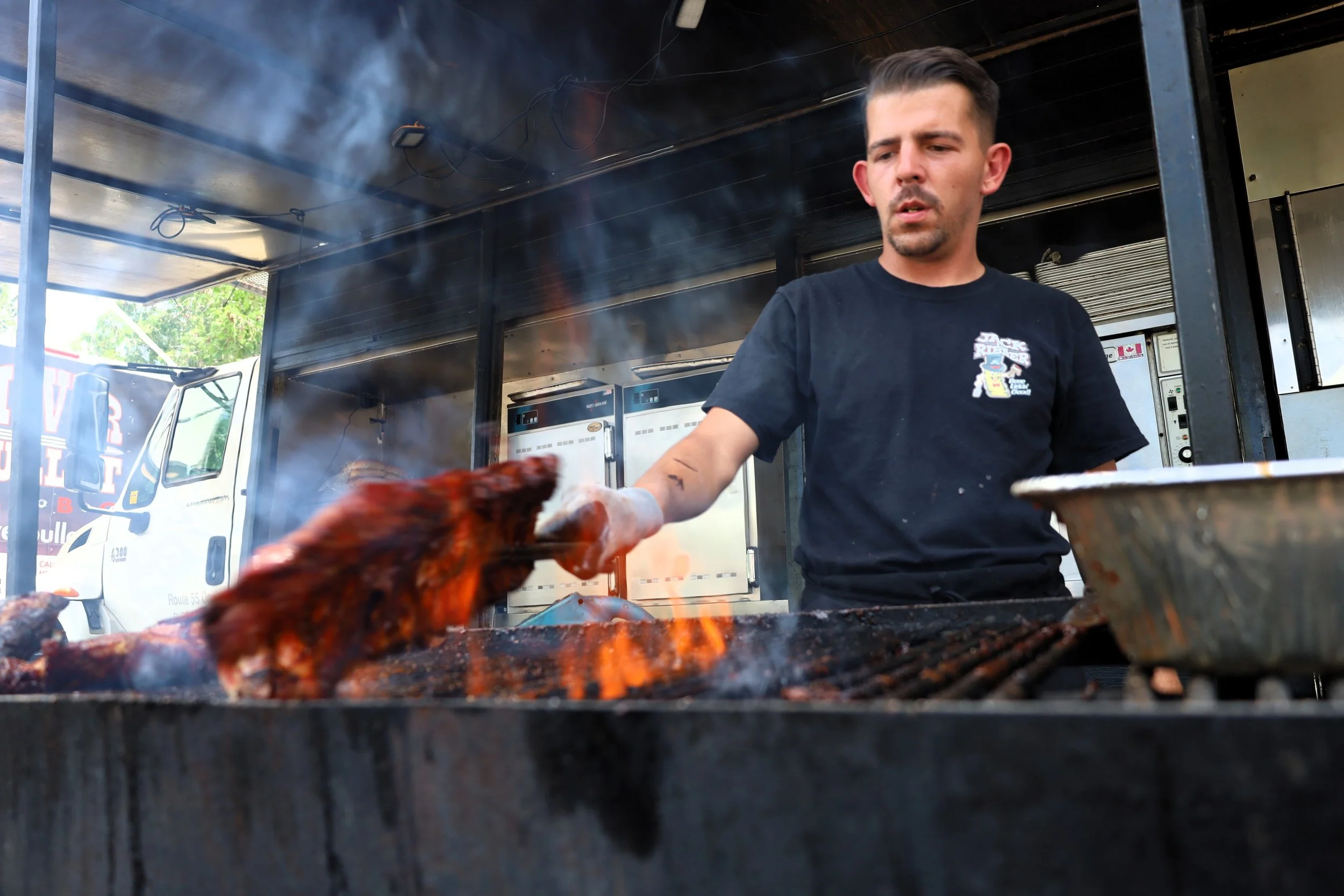 Giovanni Spina of Jack the Ribber gets a delicious rack of ribs ready for a hungry customer. They are one of four rib vendors at this year's Ribfest. All photos by David Tuan Bui.