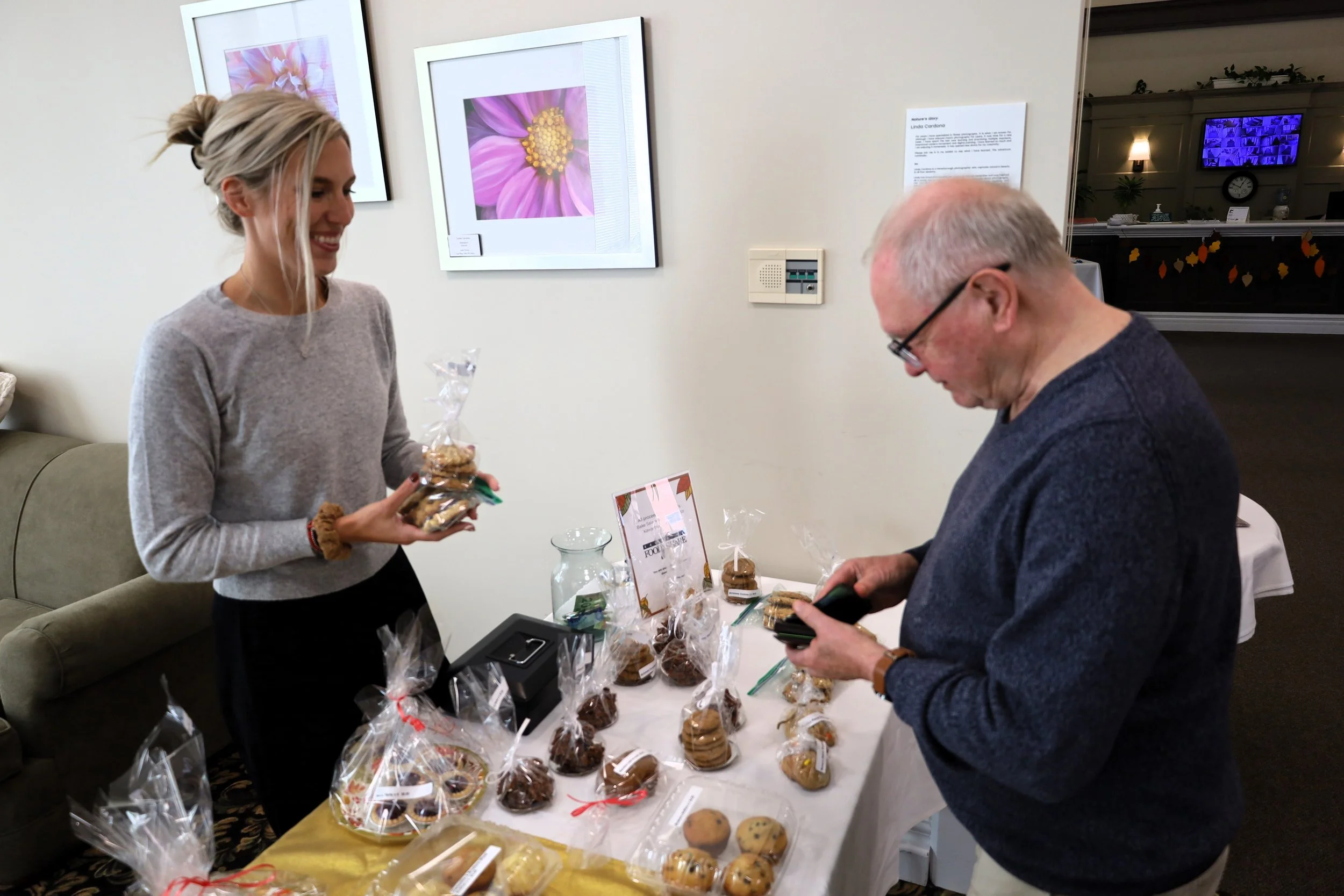 Ashlee Aitken, Kawartha Food Share general manager (left) helps a customer select baked goods made by AON Inc. staff. All photos by David Tuan Bui.