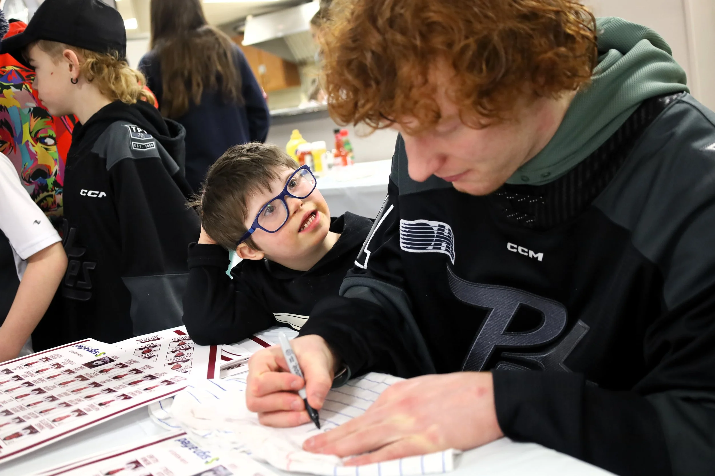 Petes goaltender Zach Bowen signs the first autograph for Tyanna Martin, 7, after the team had finished practice at the Havelock Community Centre. All photos by David Tuan Bui.