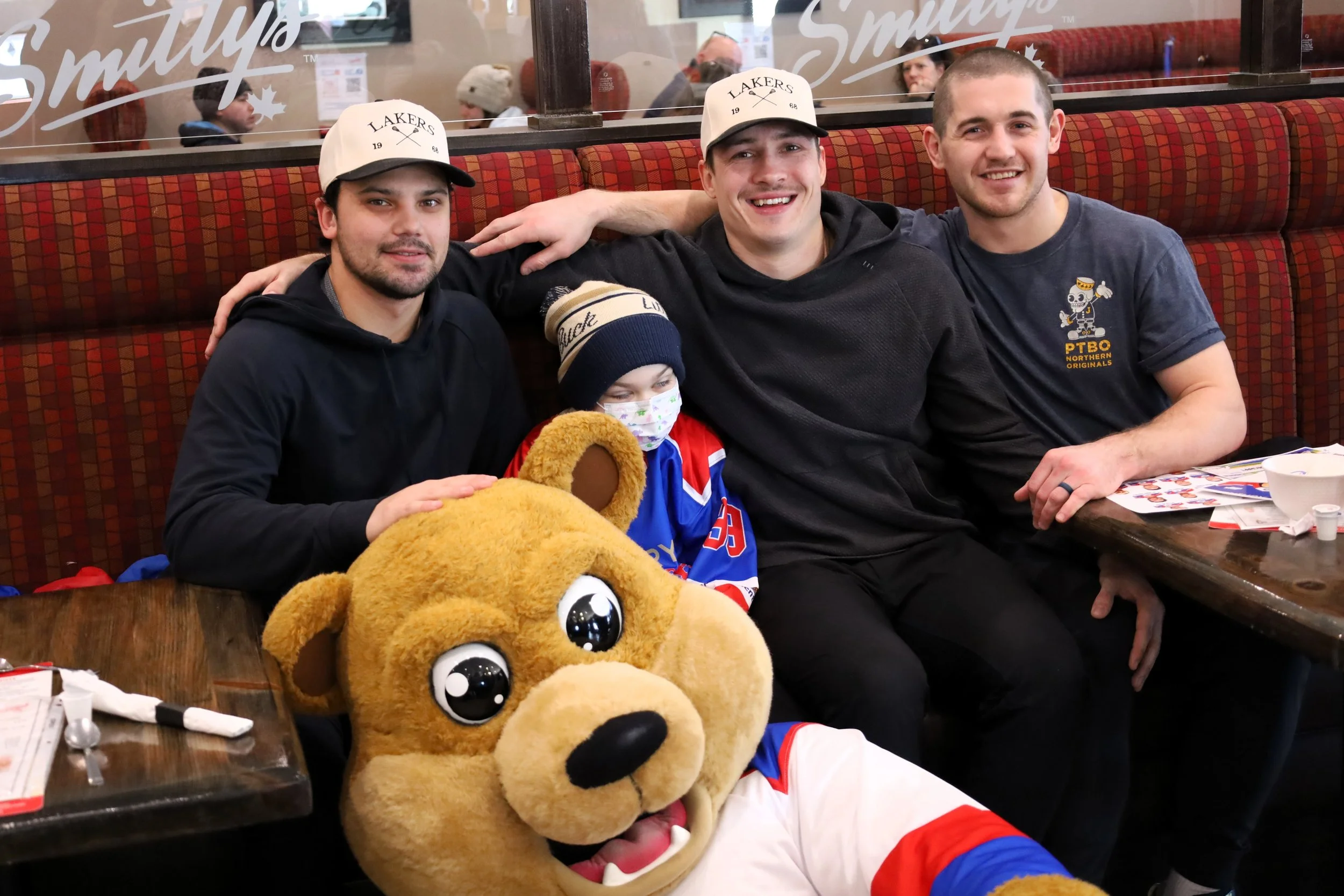 Lakers Taite Cattoni, Colton Armstrong, Jake Withers and mascot Teddy giving a young fan Waylon Barton, 7, a jersey. All photos by David Tuan Bui.