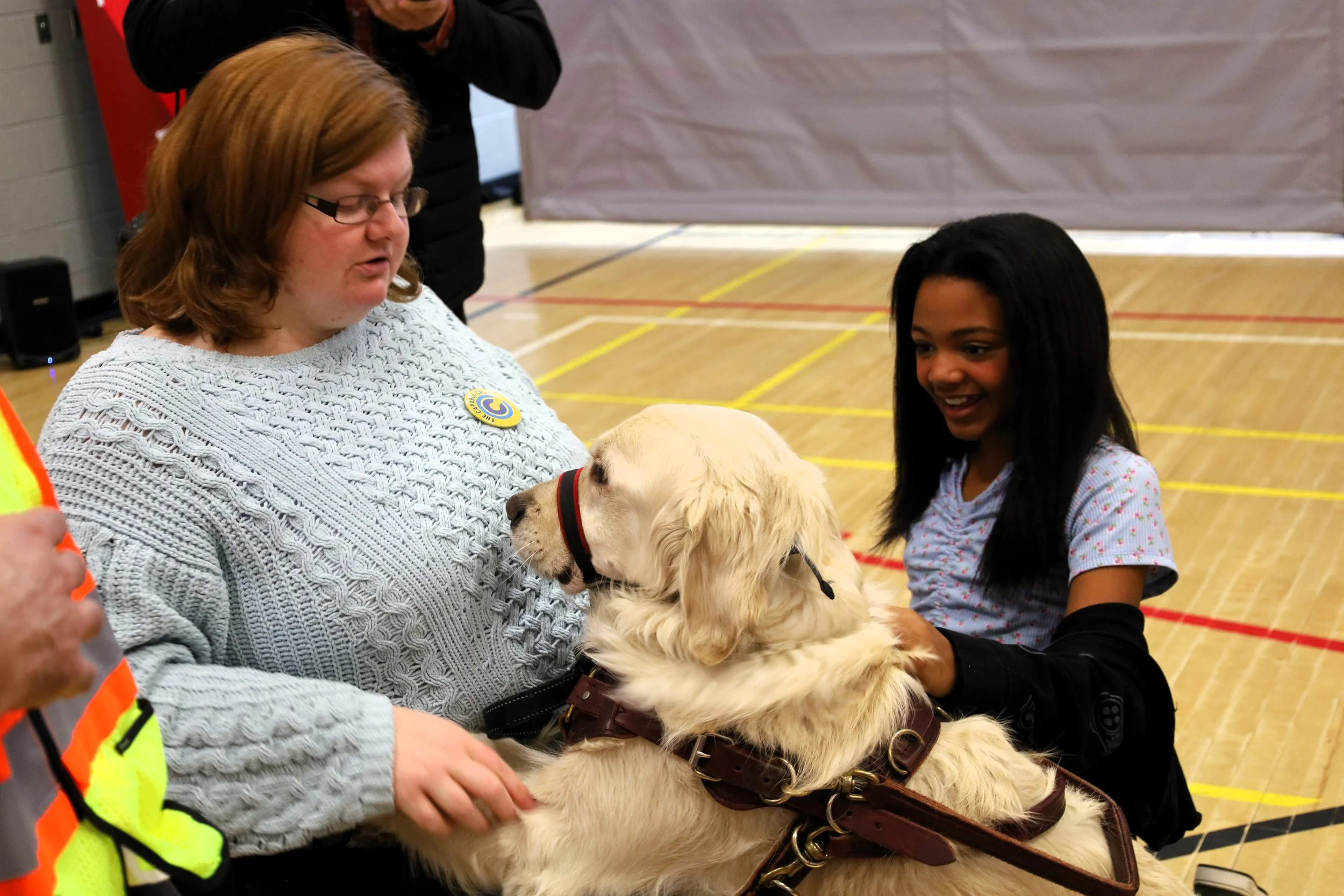 Alexandra Clay (left) with her guide dog Oliver, putting on a demo for Grade 6 student Jaja Might (right). All photos by David Tuan Bui.