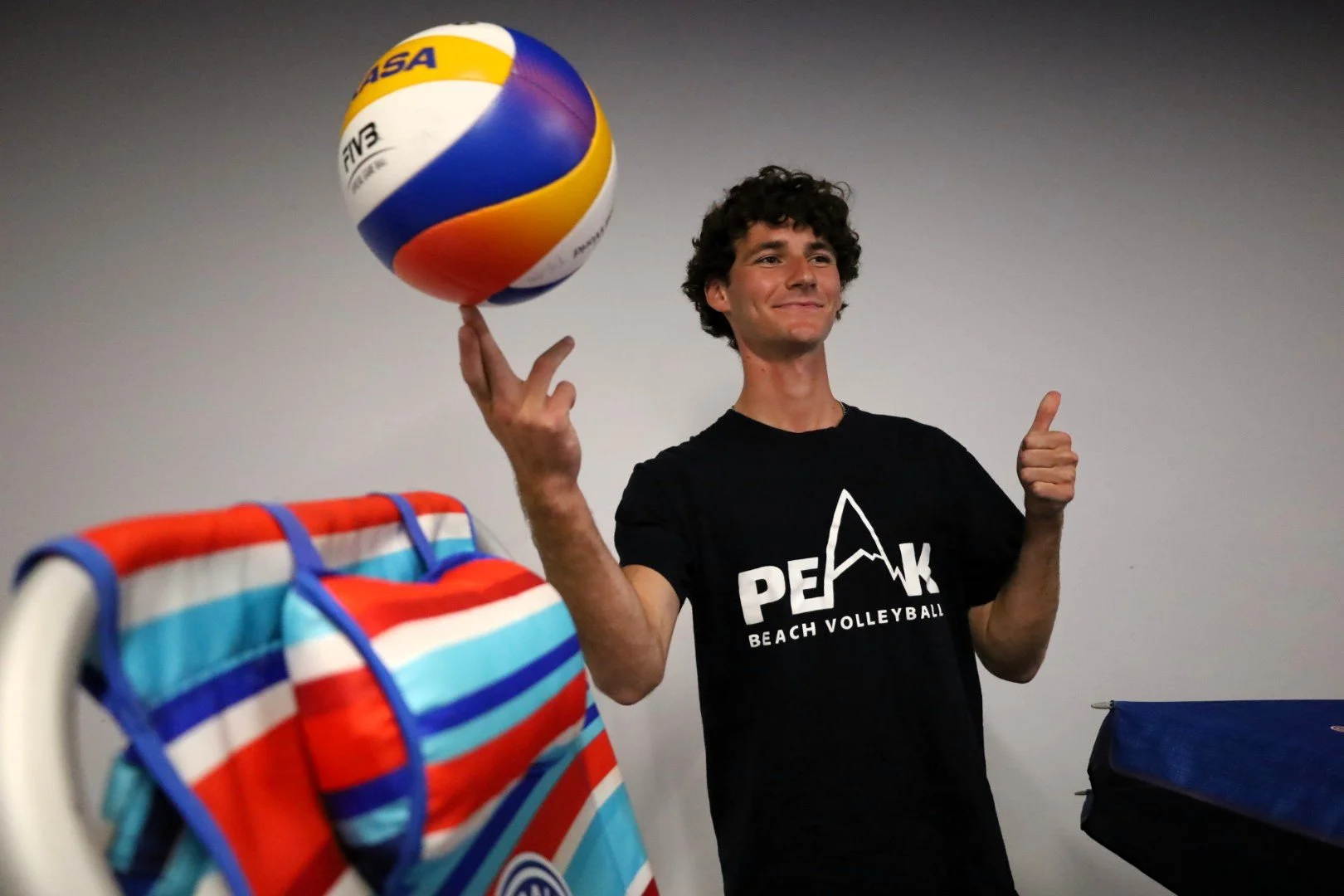 Rutger Huntley, Peak Beach Volleyball owner, spins one on his finger while showcasing his brand after graduation. All Photos by David Tuan Bui.