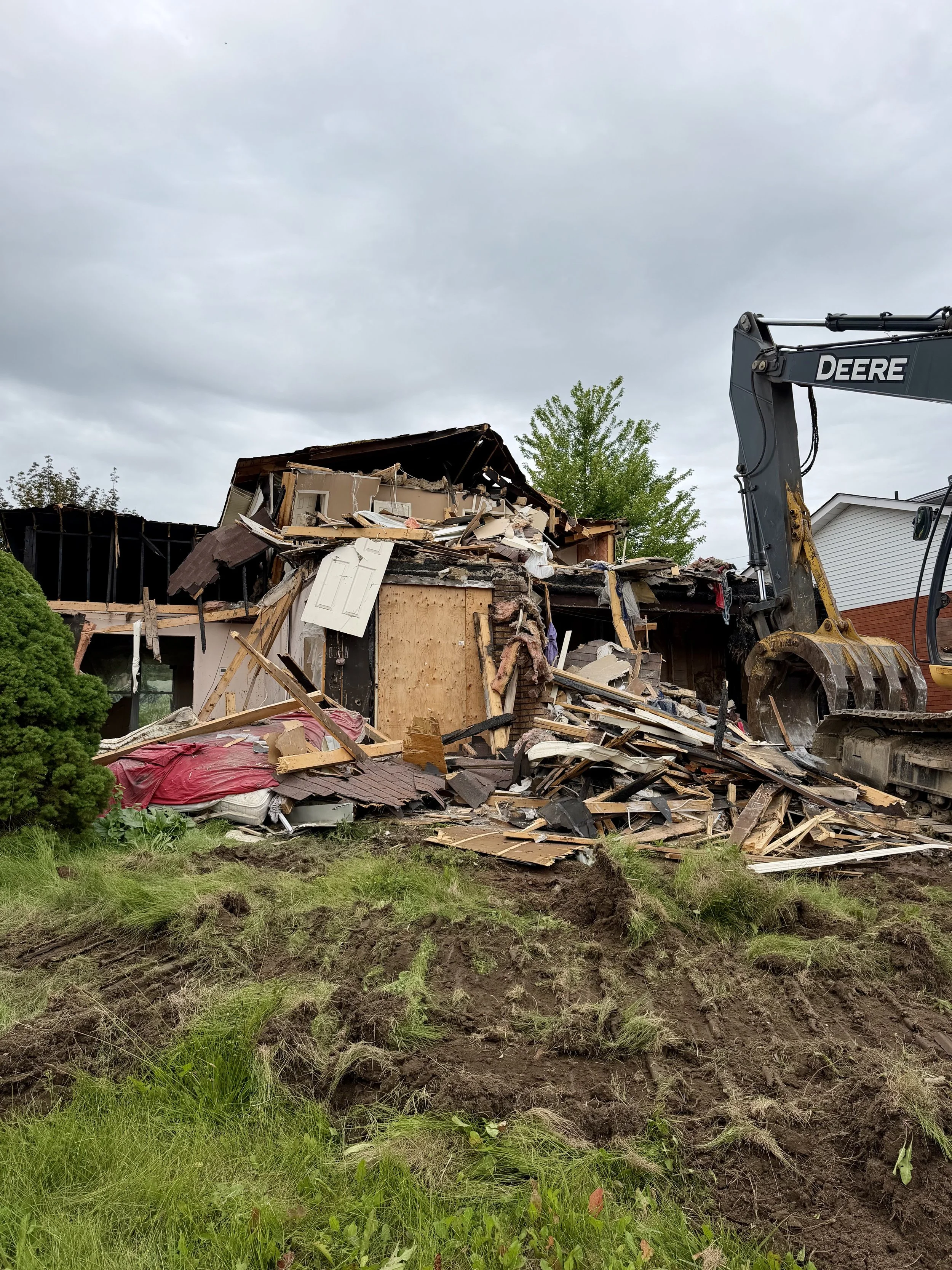 After years of standing vacant, the burned-out Woodglade Boulevard home is finally being demolished. (Photo by Scott Arnold)