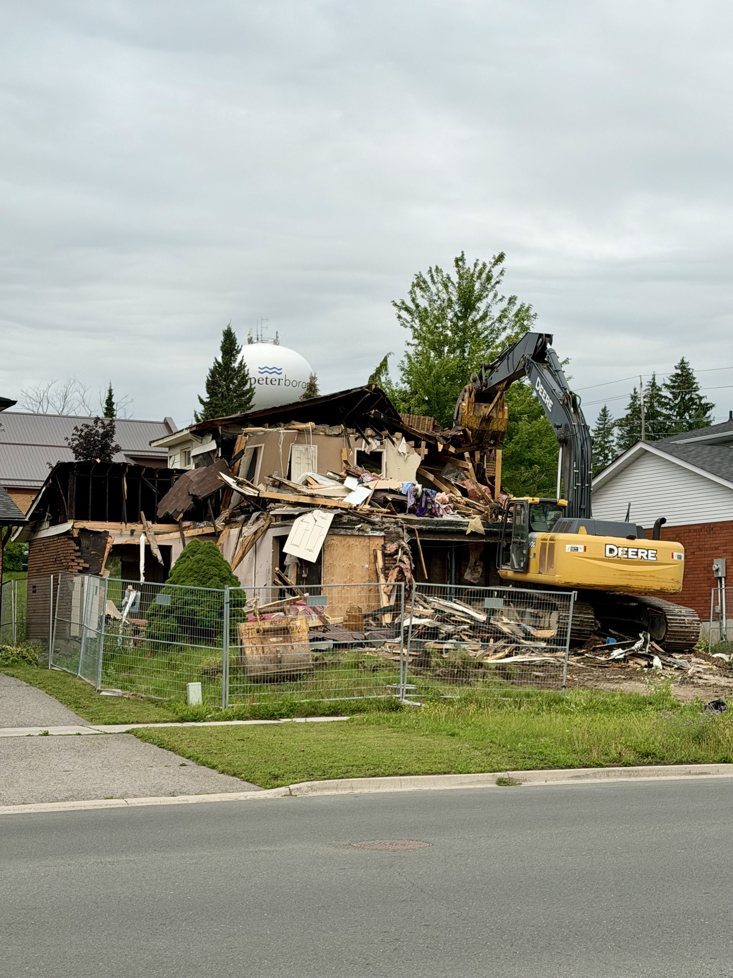 After nearly four years, the burned-out home on Woodglade Boulevard is finally coming down.