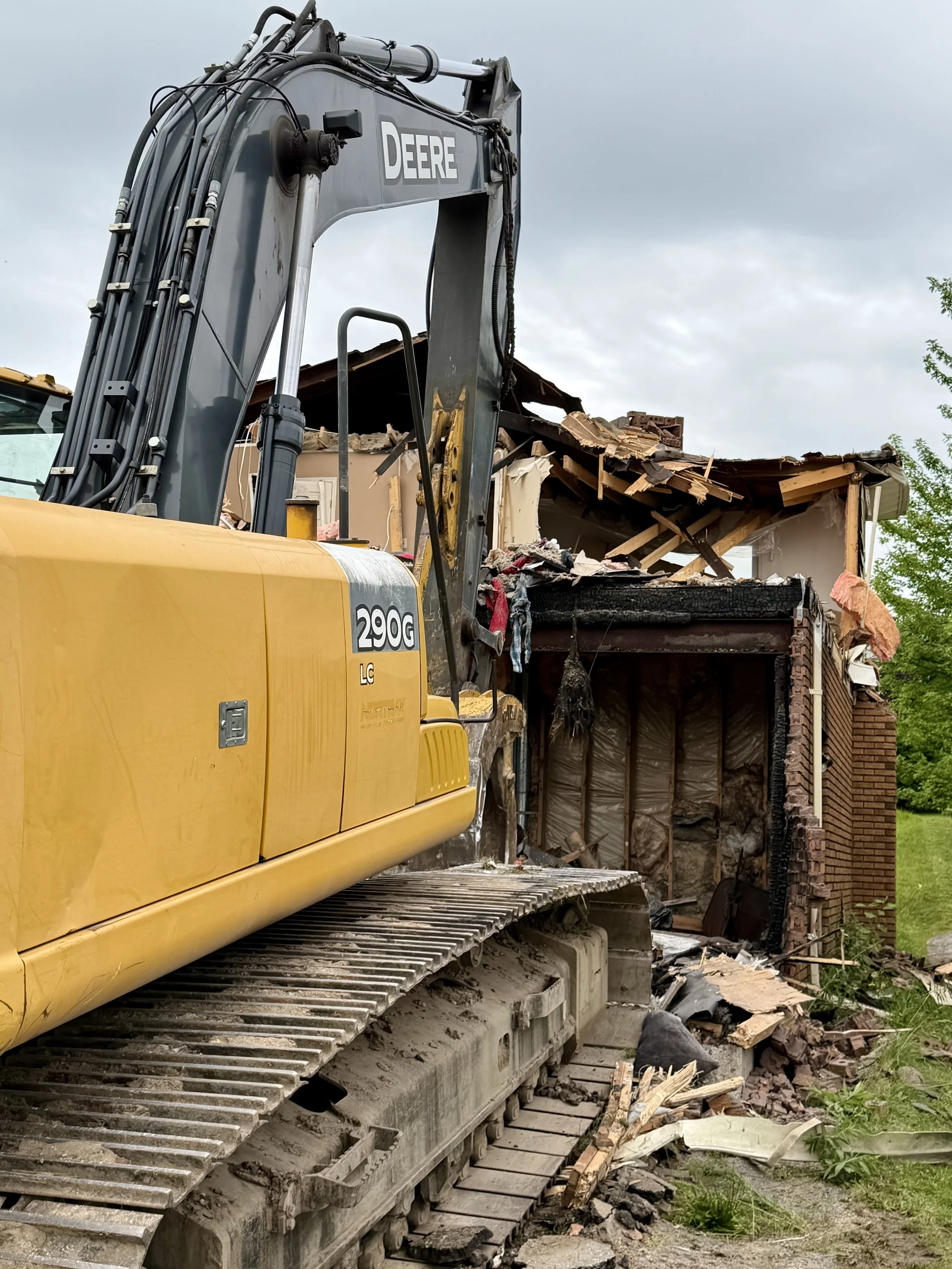Piece by piece, the damaged Woodglade Boulevard home is being taken down Monday morning. (Photo by Scott Arnold)