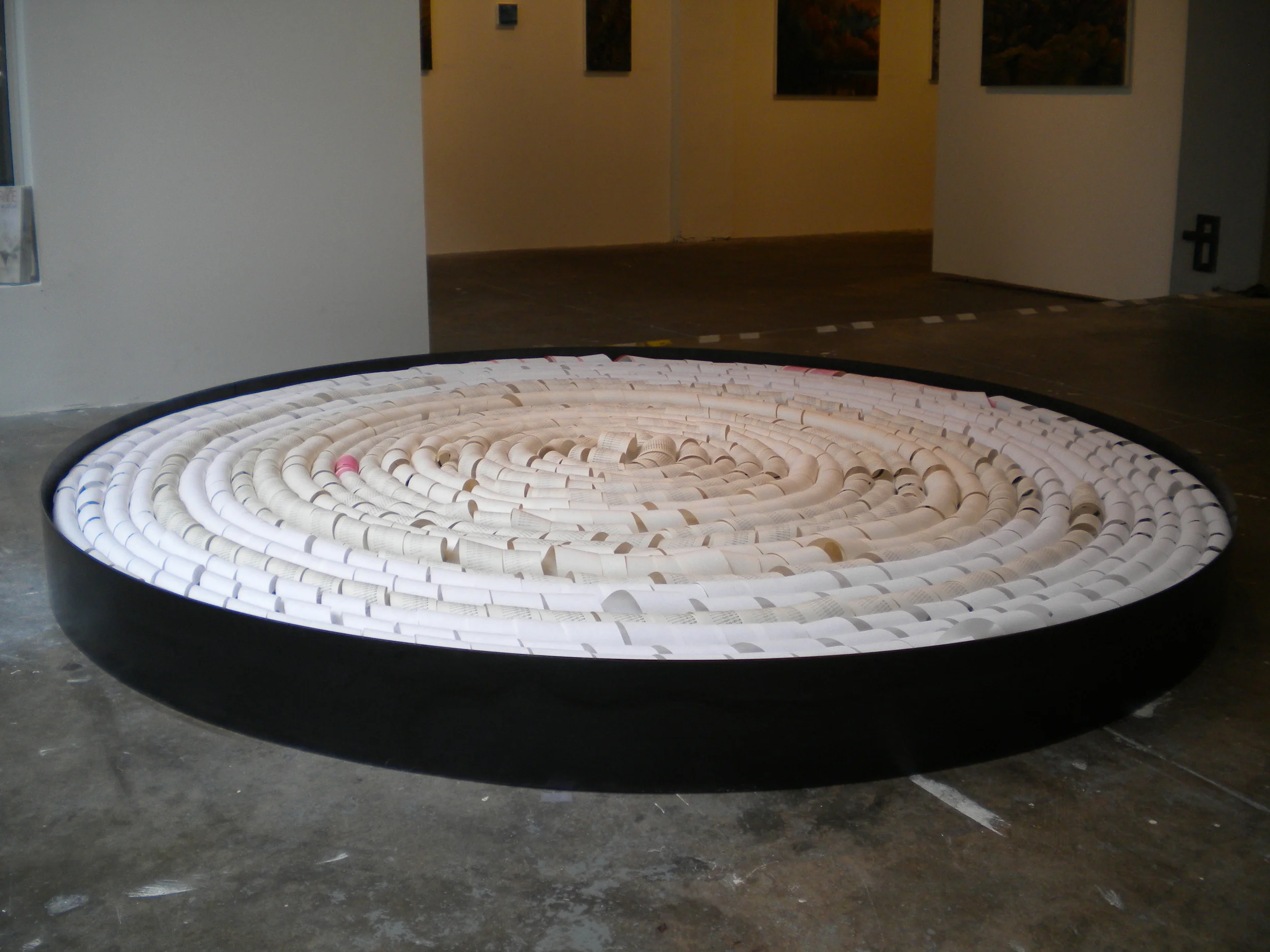   Countdown.  6 ’4” Diameter.  Steel, found adding machine paper, ink.  Countdown  is a mandala "a container of essence", a microcosm of the universe from the human perspective. It is the result of the ritual of entering each day, month and year from