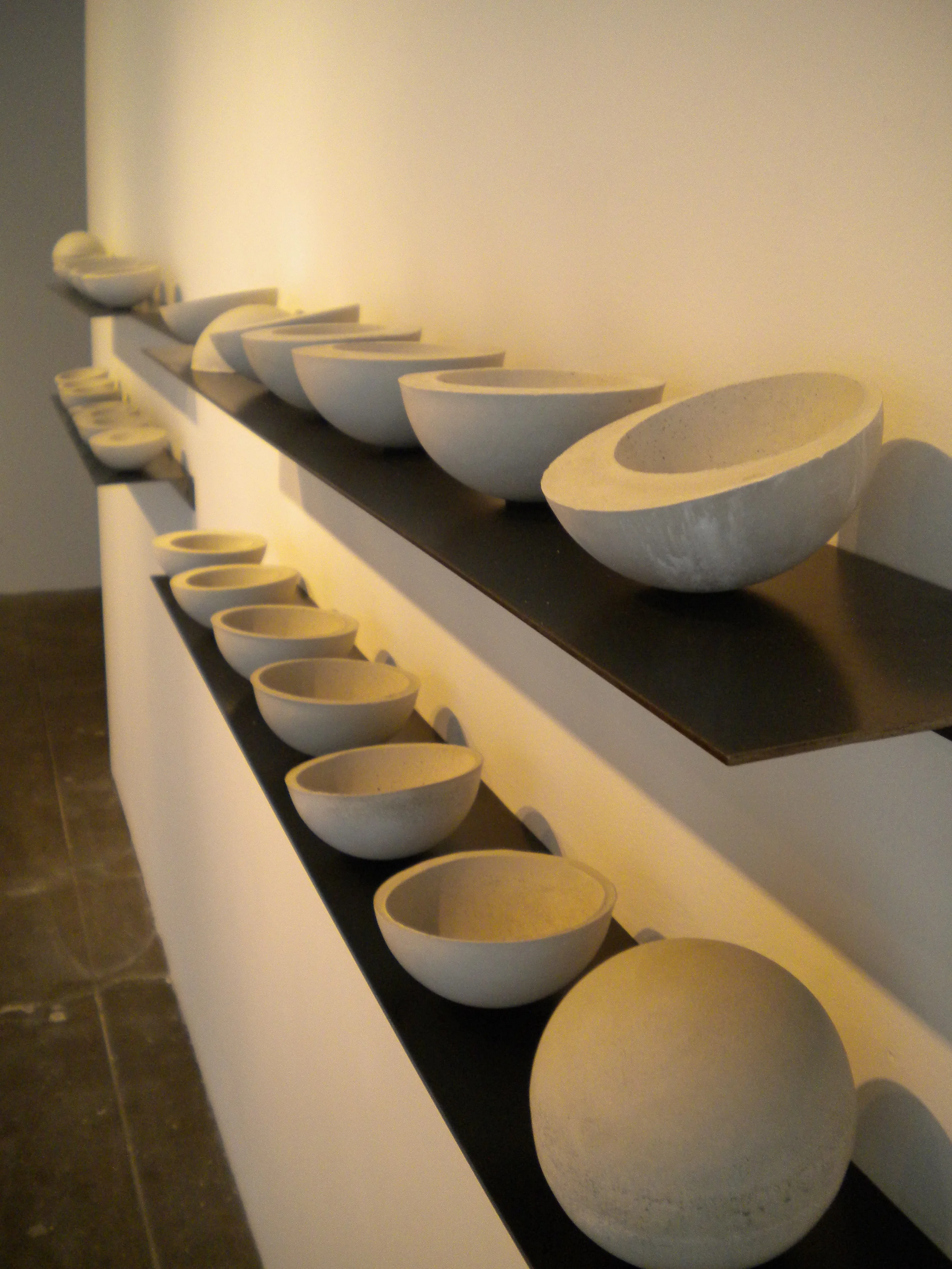   It was more than just a day.   14’ x 12”.  Cast concrete, steel.  A progression of solids and voids, the waxing and waning of the moon. Each shelf represents a week, totaling a month, the lunar cycle of the duration of the show. This distilled appr