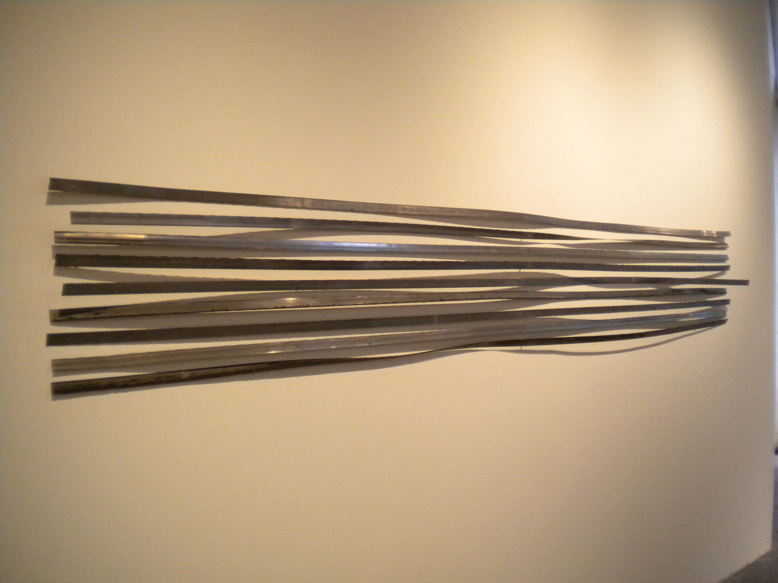   Missing Teeth.  10’x 13”.  Tempered steel band saw blades from my horizontal band saw.  Collected and saved since moving into SODO shop (5 years) 