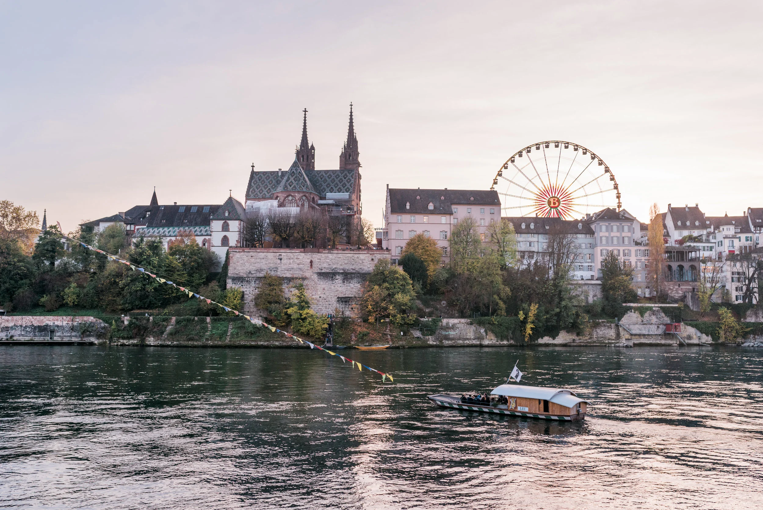Basel skyline, city boat and the ferris wheel of the Autumn Fair.