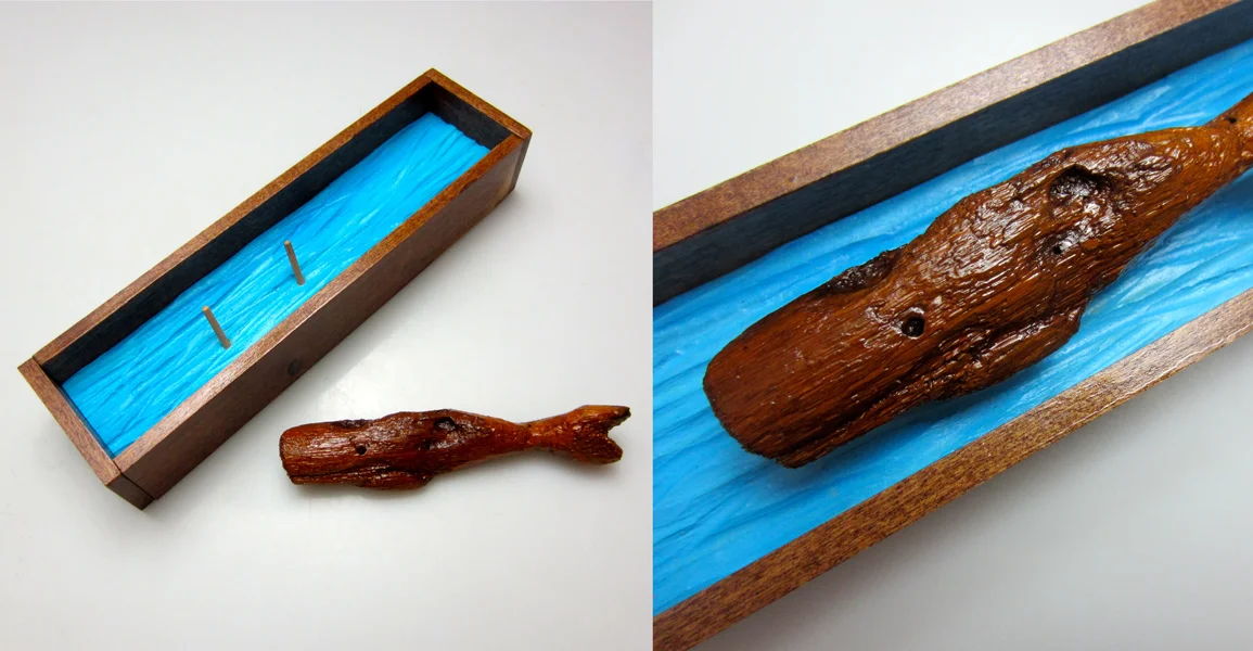 VT River Whale A tiny, freshwater whale coaxed from driftwood, tucked into a tiny shadow box sea. 9 x 2-3/8 x 1-1/2 inches river driftwood & amber varnish, with poplar, pine, and acrylic paint
