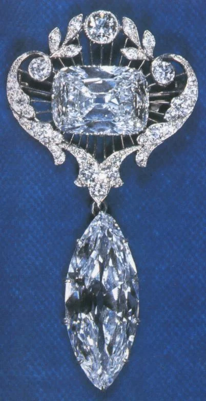 The Cullinan was split and cut into 7 major stones and 96 smaller stones. Edward VII had the Cullinan I and Cullinan II set respectively into the Sceptre with the Cross and the Imperial State Crown while the remainder of the seven larger stones and the 96 smaller brilliants remained in the possession of the Dutch diamond cutting firm of Messers I. J. Asscher of Amsterdam who had split and cut the Cullinan, until the South African Government bought these stones and the High Commissioner of the Union of South Africa presented them to Queen Mary on 28 June 1910. Cullinan I is a 530.2 carat, pear cut diamond and the largest of the Cullinan diamonds. It is also known as the Great Star of Africa, and was set in the head of the Sceptre with the Cross which was reworked for this purpose. It may also be hung as the pendant, on its own or from Cullinan II in a brooch. For this purpose the diamonds have both been fitted with two tiny platinum loops on the edges. Cullinan II, the Second Star of Africa, weighing 317.4 carats and having a rectangular cushion cut, was set in the front of the circlet of the Imperial State Crown. It may also be used together with Cullinan I as a brooch. Cullinan III is a pear cut, 94.4 carat diamond known as one of the Lesser Stars of Africa (along with Cullinan IV). Queen Mary, the queen consort of George V, had Cullinan III set in the surmounting cross of her new crown for her coronation in 1911. In 1914, however they were replaced by crystal models. After that, Queen Mary mainly wore the crown as a circlet, meaning Cullinan III was not needed. Since Queen Mary's death on March 24, 1953 her consort crown has remained unworn and it is thus unknown if Cullinan III will ever be used again to surmount the Crown of Queen Mary. Presently Cullinan III is most frequently worn as a brooch, in combination with Cullinan IV. Cullinan IV is square cushion cut and weighs 63.6 carats. It was also set in the crown originally, as part of the circlet, However it too was removed in 1914. Since then it was been worn as a brooch along with Cullinan III. Collectively the two diamonds are affectionately known as 'Granny's Chips', by Queen Elizabeth II. This was revealed by Queen Elizabeth II on the 25th of March 1958, while she and Prince Philip were on a state visit to the Netherlands. As part of their tour of the country, the couple visited the Asscher diamond works, where the diamond had been cut fifty years earlier. The occasion marked the first time the Queen had publicly worn the brooch. During the event, the Queen unpinned the brooch and offered it for examination by Louis Asscher, the brother of Joseph Asscher, who had originally cut the diamond. Elderly and almost blind, Asscher was deeply moved by the fact the Queen had brought the diamonds along with her, knowing how much the gesture would mean to him, seeing the diamonds after so many years. The Queen has worn the brooch no more than six or seven times in public during her reign. Cullinan V is heart cut and weighs 18.8 carats. It is set in the center of a brooch forming a part of the stomacher of the diamond and emerald Delhi Durbar Parure. The brooch was designed to show off Cullinan V and has a large number of smaller stones set around it. The brooch can also be attached to Cullinans VI and VII to become a large stomacher, often worn by Queen Mary. Queen Elizabeth II has worn this brooch many times, perhaps making it her most worn piece of jewellery. Cullinan VI is also marquise cut and weighs 8.8 carats. It hangs from the brooch containing Cullinan VIII and forming part of the stomacher of the Delhi Durbar Parure. Cullinan VI along with Cullinan VIII can also be fitted together to make yet another brooch, surrounded by some 96 smaller diamonds. The design was created around the same time that the Cullinan V heart shaped brooch was designed, with them both having a similar shape. Cullinan VII is marquise cut and weighs 11.5 carats. Originally given by Edward VII to Queen Alexandra. After his death she gave this stone to Queen Mary, who had it set as a pendant hanging from the diamond and emerald Delhi Durbar Necklace, of the Delhi Durbar Parure. The Cullinan VIII is set in the center of a brooch forming part of the stomacher of the Delhi Durbar Parure. It is cushion cut and weighs 6.8 carats. Together with the Cullinan VI it forms a brooch. Queen Elizabeth II inherited this brooch in 1953, however in contrast to the Cullinan V heart brooch, she has never been seen wearing it in public, claiming that 'it gets in the soup'. The Cullinan IX is the final large diamond to be obtained for the Cullinan. It is pear cut and weighs 4.4 carats. It is set in a platinum ring, known as the Cullinan IX Ring.