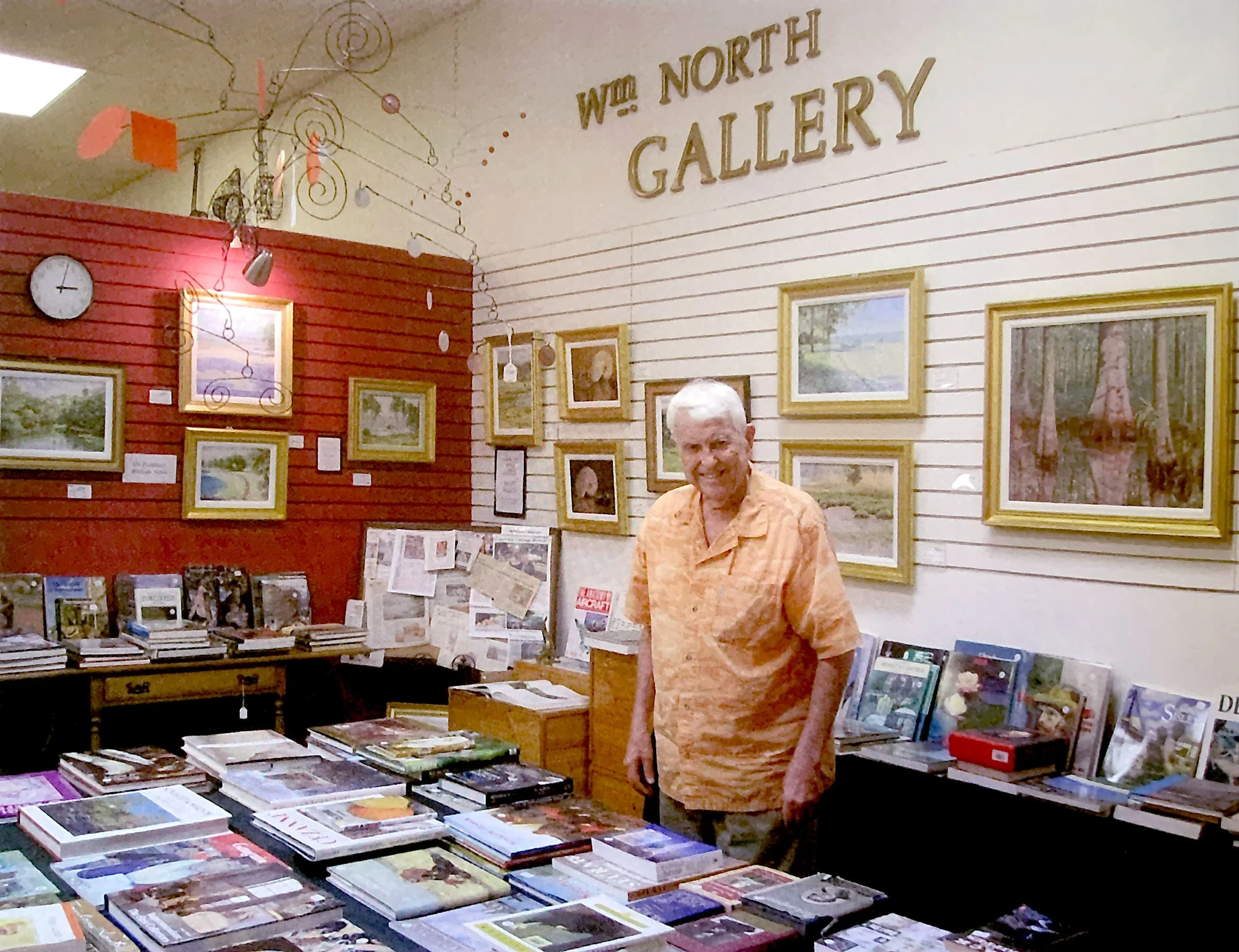 American painter William North in his gallery surrounded by books and artwork