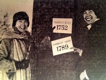 Former Director Martha Vinick and Assistant Director Lee Zimmerman hang a new sign on the Saltbox Gallery after discovering it is 37 years older than previously thought.