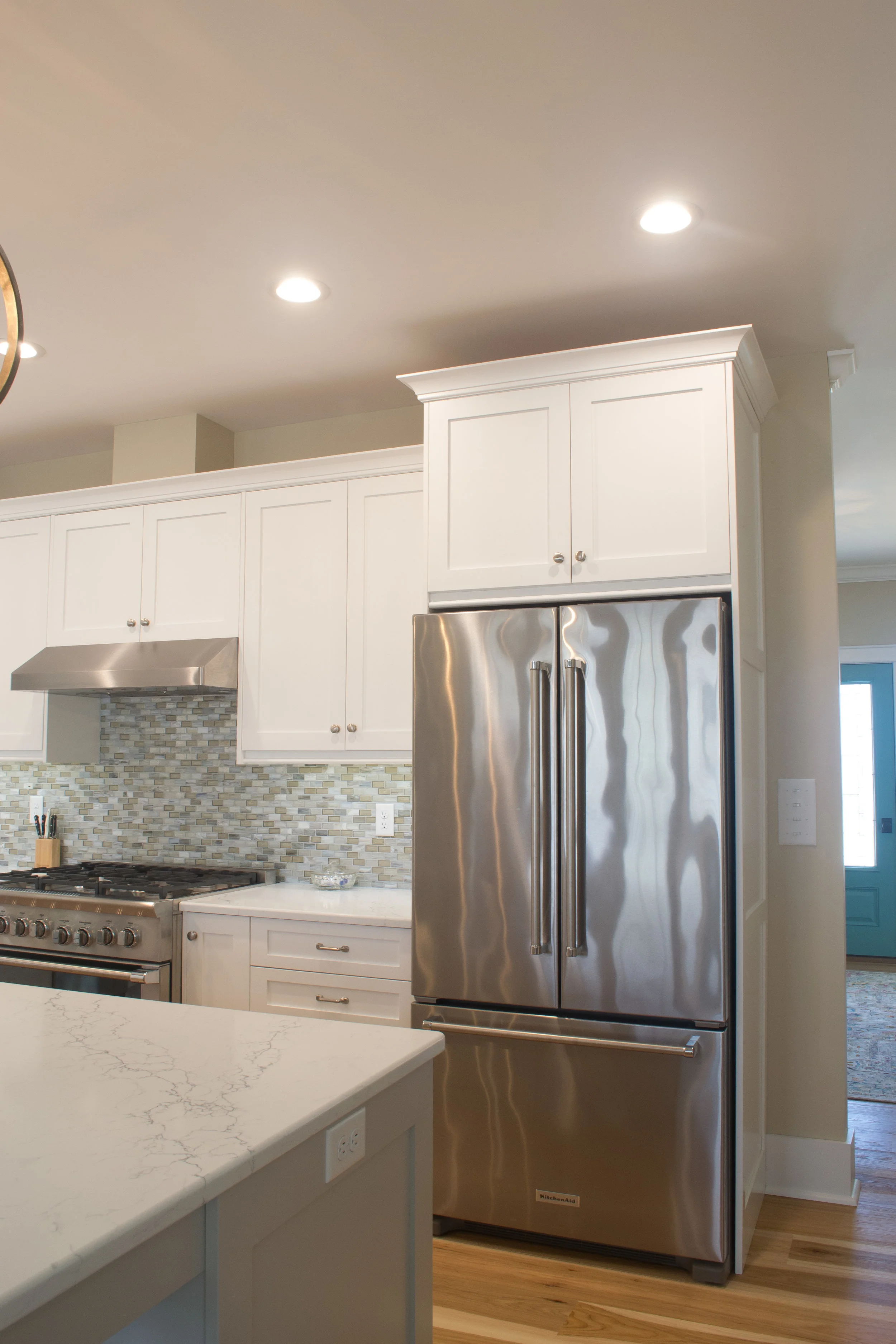 White painted kitchen with a cabinet for a hidden t.v.