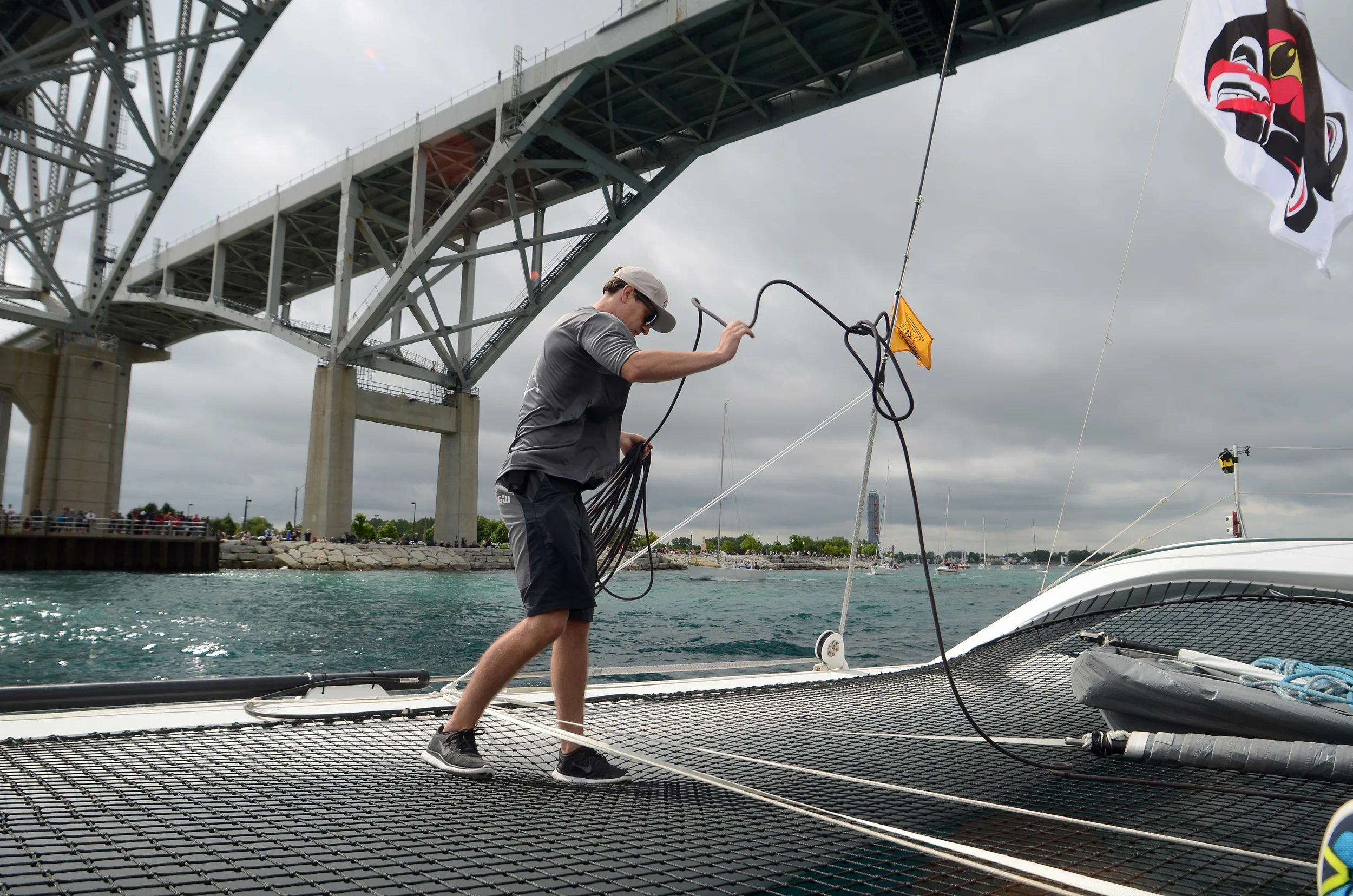 Matt secures a line under the Blue Water Bridge heading out to the start of the Mackinac Race.