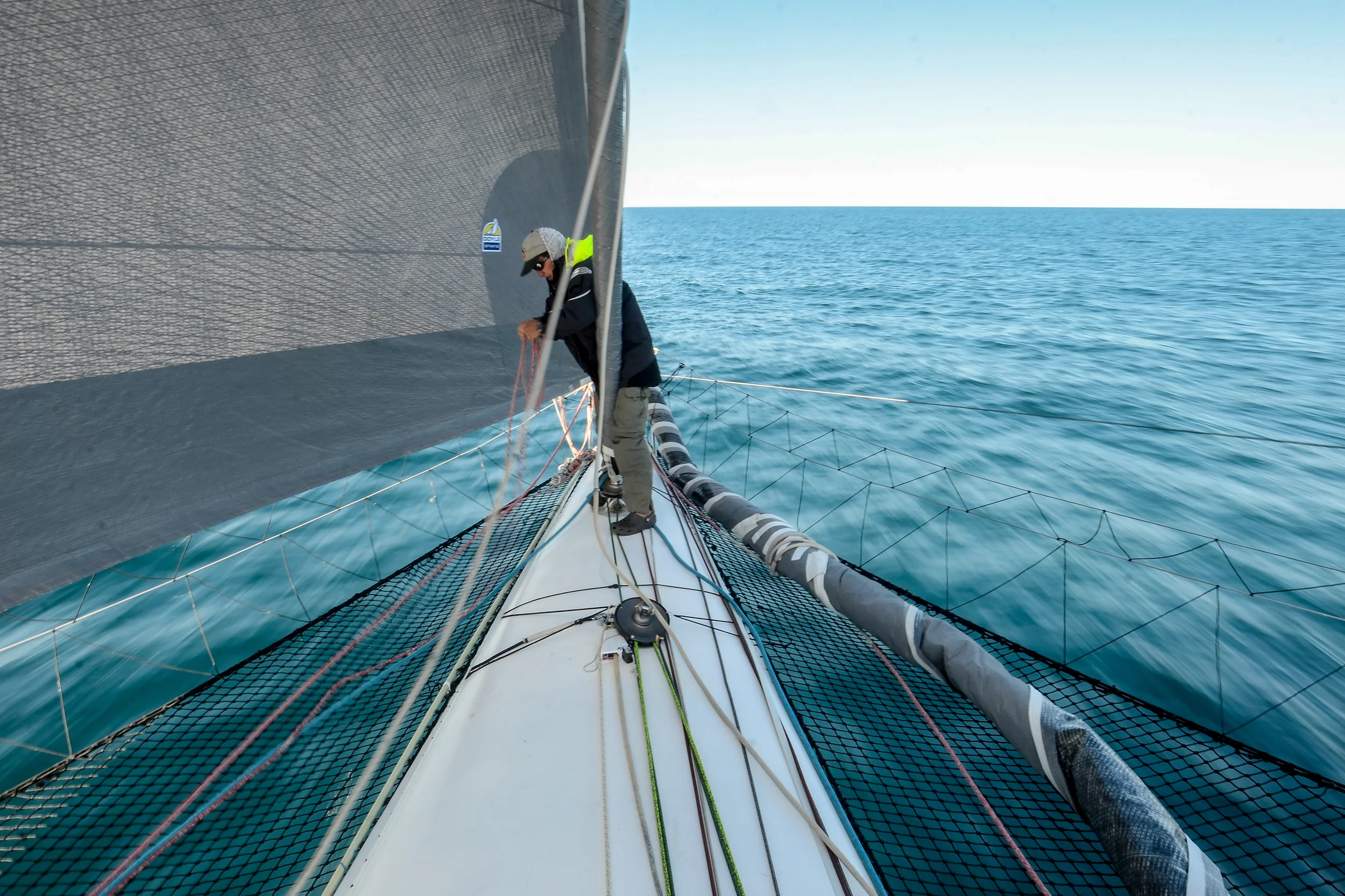 Mike adjusts a sail at the start of the race.