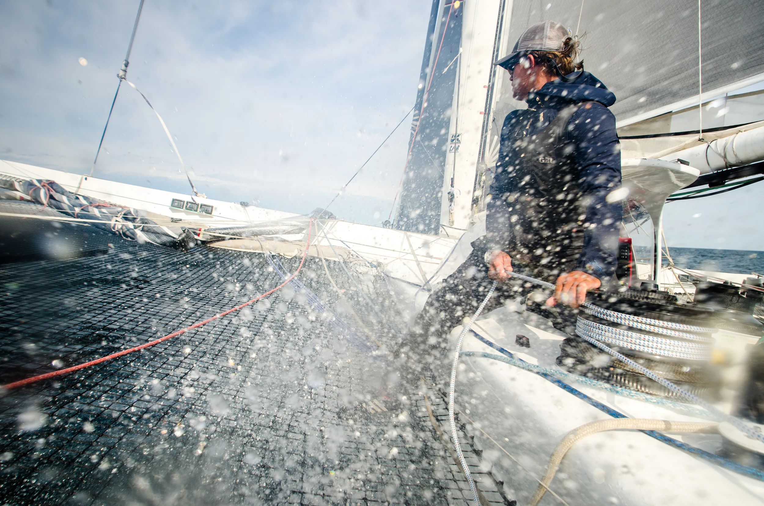 Donny takes a face full of spray as a wave hits the bow and pushes water up through the netting.