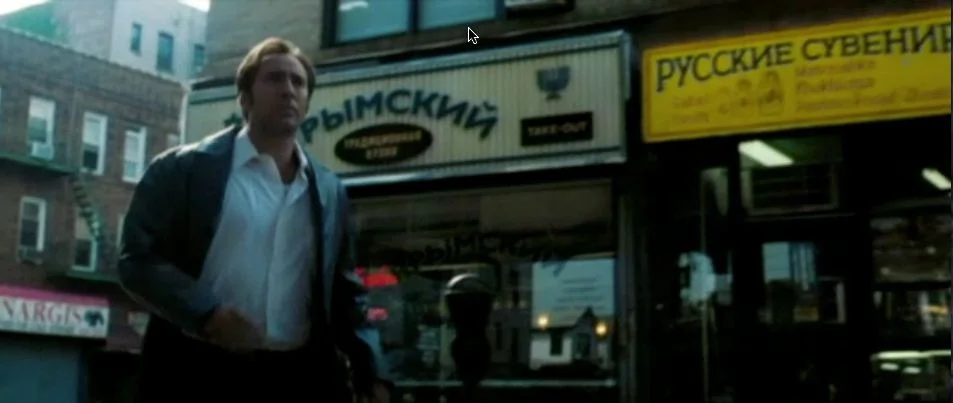 Still Showing Hero Location Signage and Adjacent Store