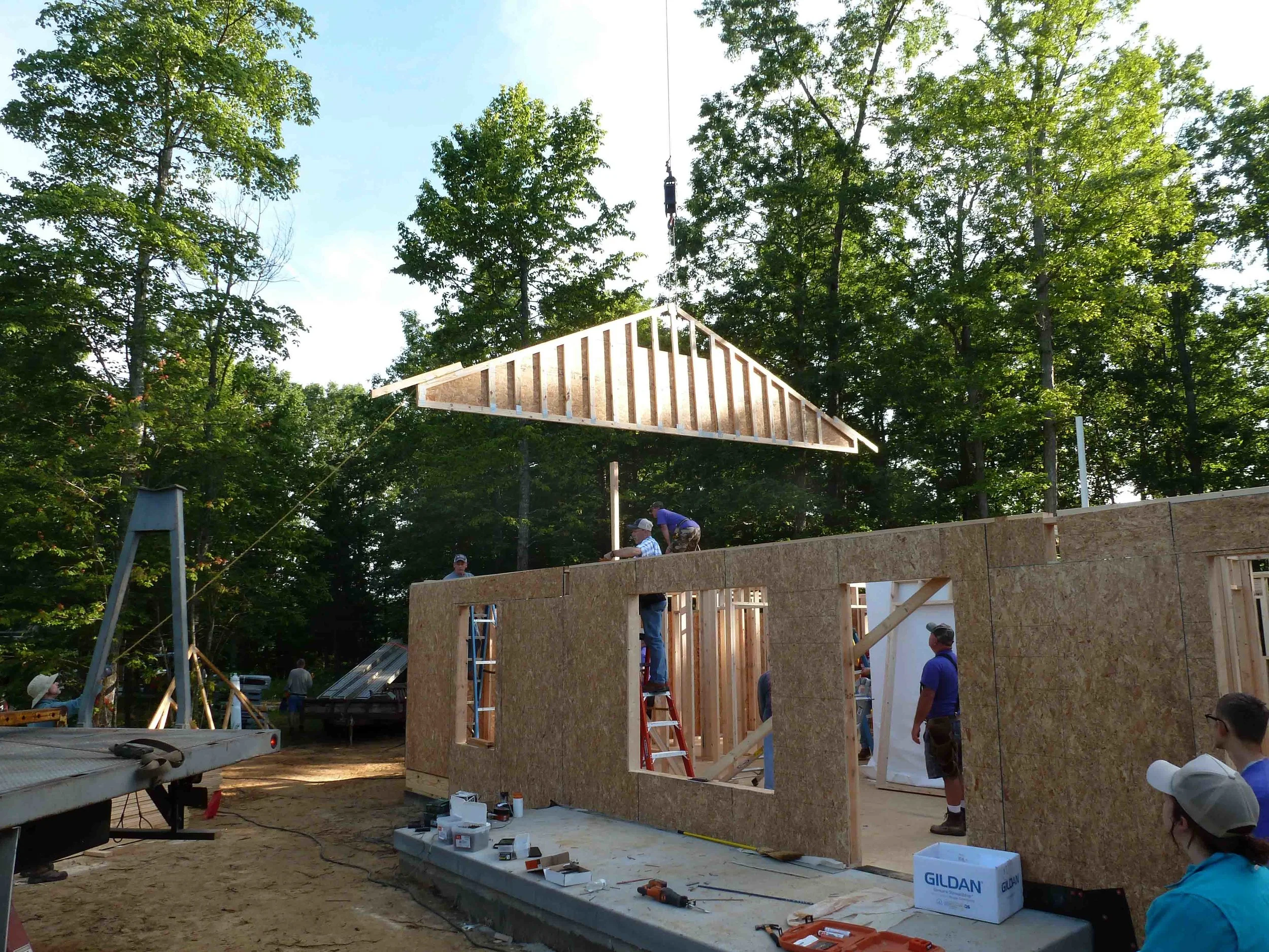 Setting the first roof truss.JPG