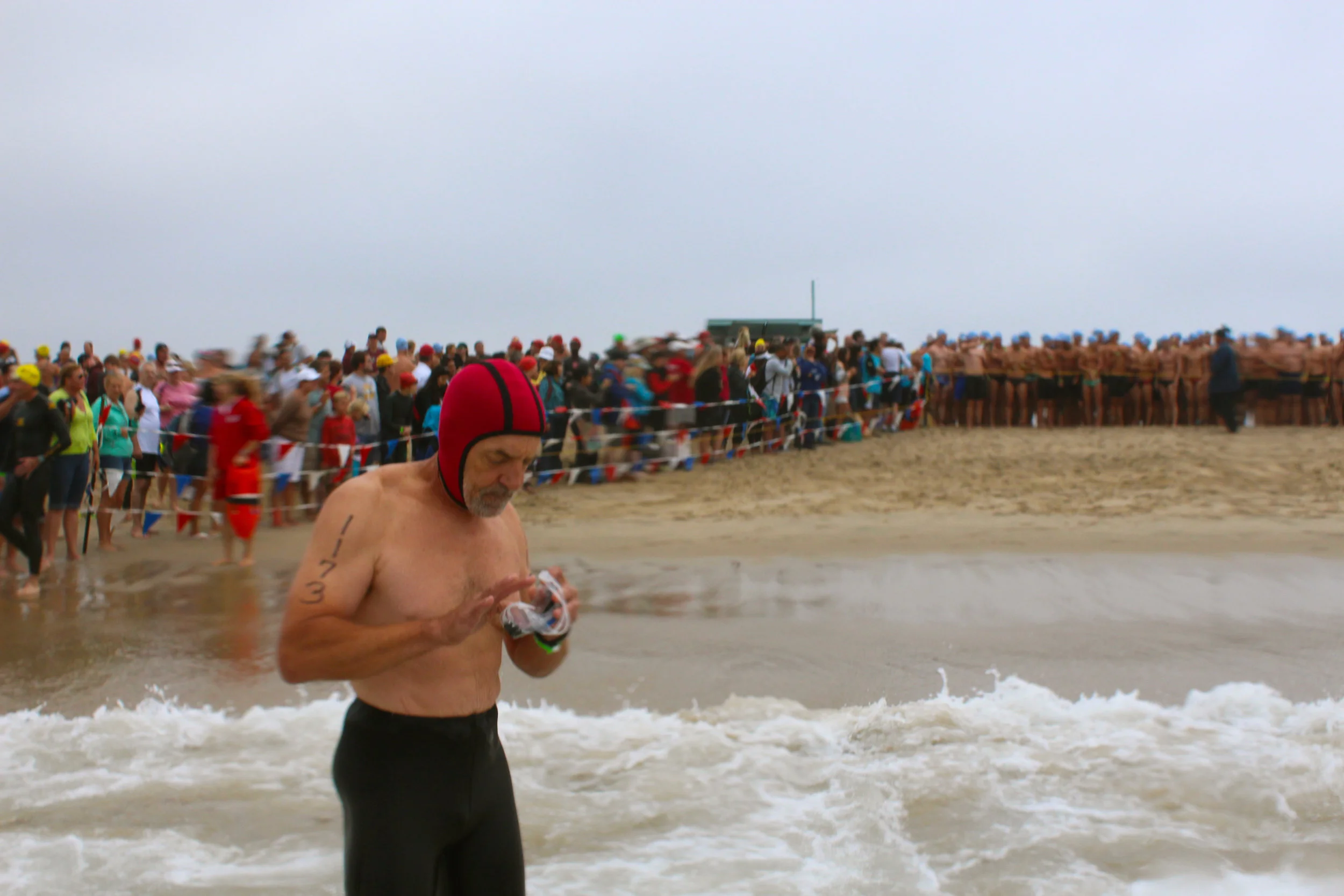 A competitor cleans his goggles in quiet mental preparation before the race. 
