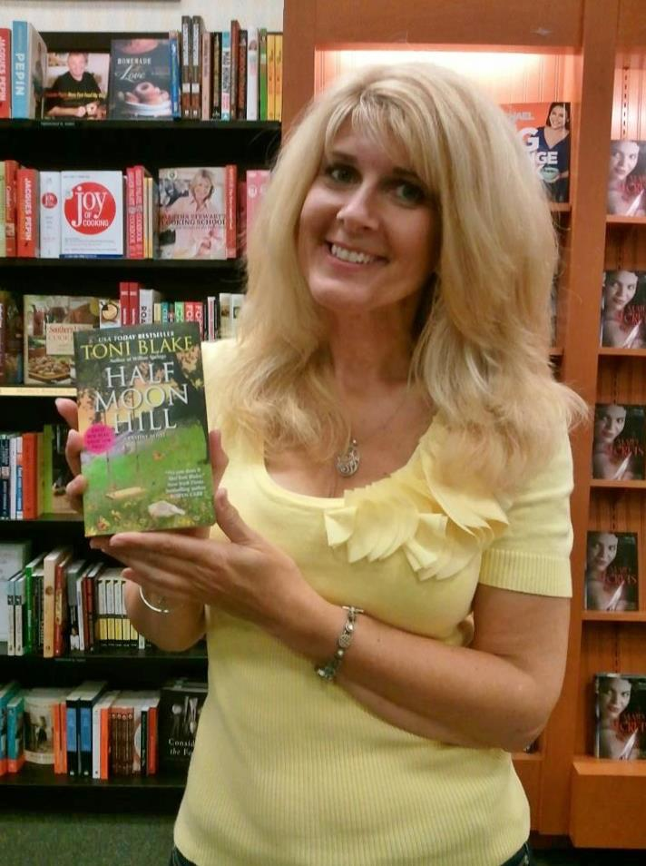 Toni with a copy of the newest Destiny book, Half Moon Hill . 