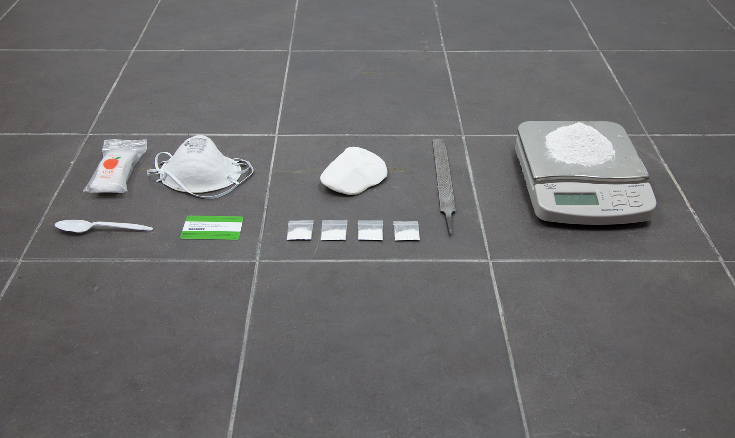 Isaac Brest This Shit Right Here, N****?! , 2013 Plastic baggies, dust mask, salvaged stone from Parthenon, metal file, salvaged stone from Parthenon filed down to powder, four plastic baggies containing one gram of Parthenon powder, Metropolitan Museum membership card, plastic spoon Dimensions variable 