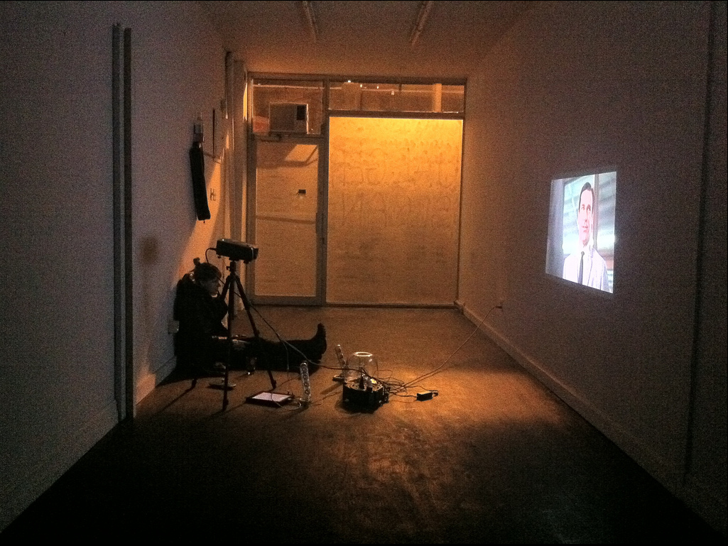 Kristin Sloan enjoying MadMen projected on the wall at 55 Clinton Street.