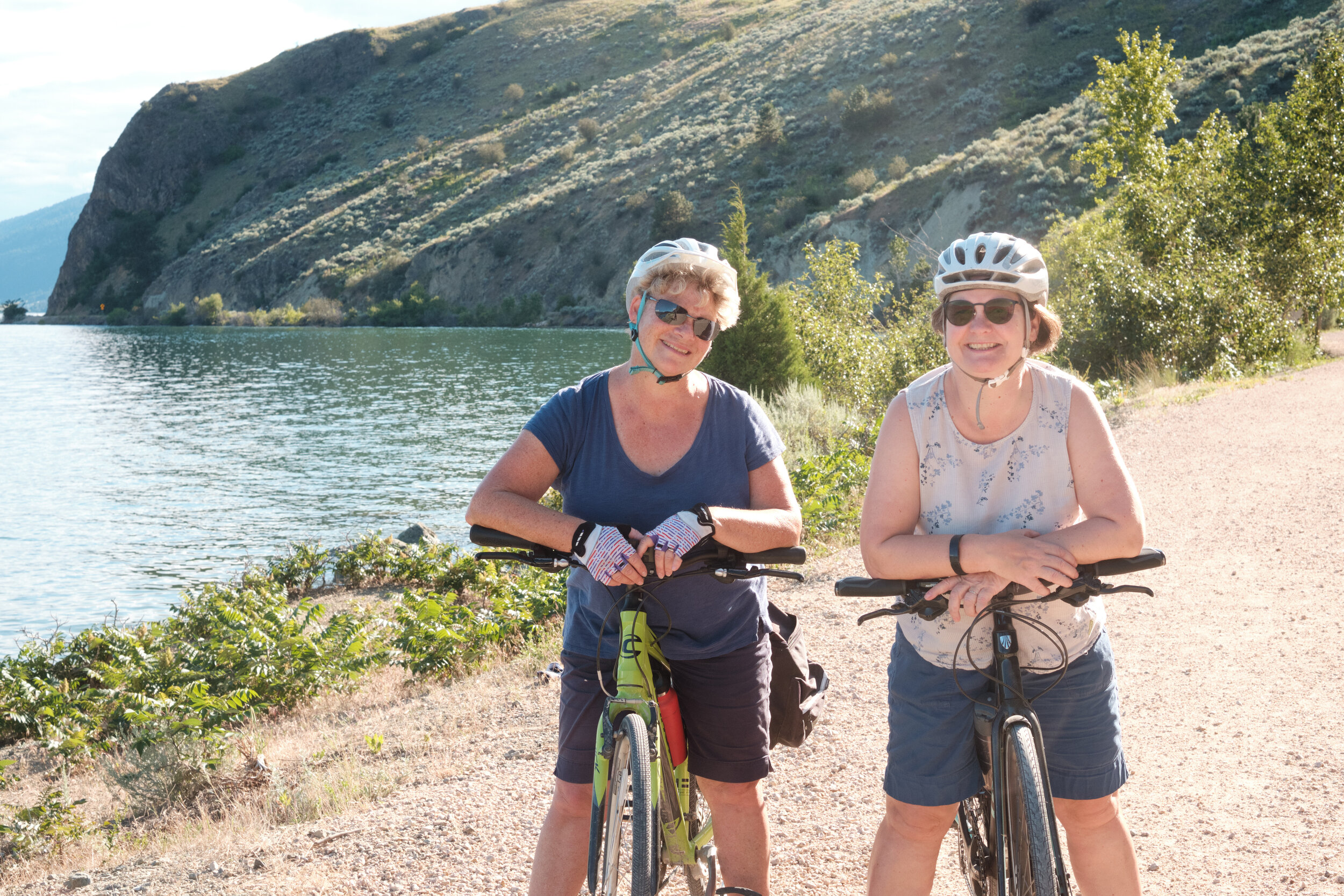 Dagny and Diana, Friends, stop for a break during a cycling trip on the Okanagan Rail Trail. 