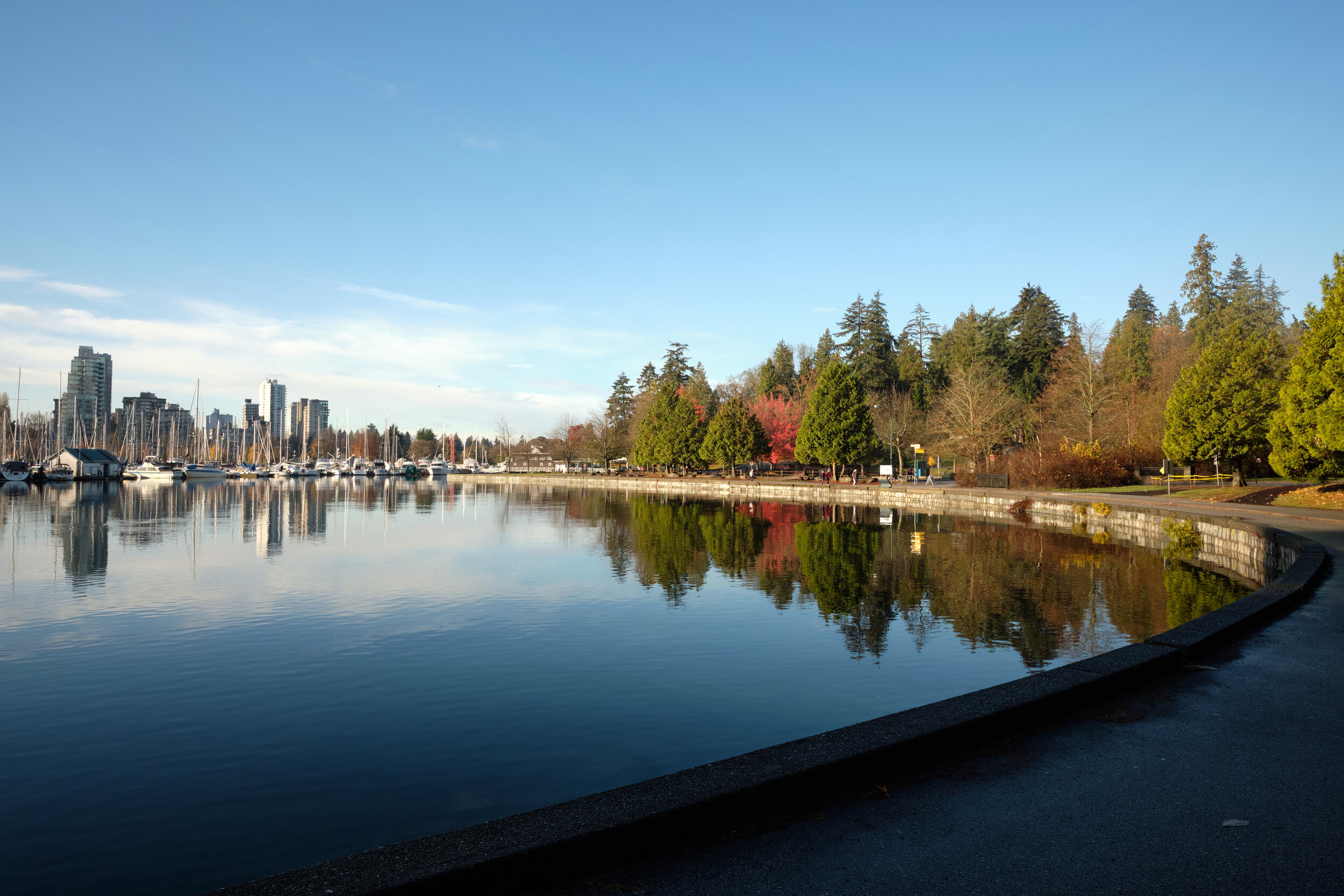 Morning light and blue skies on a November morning at Coal Harbour along the Stanley Park Seawall in Vancouver