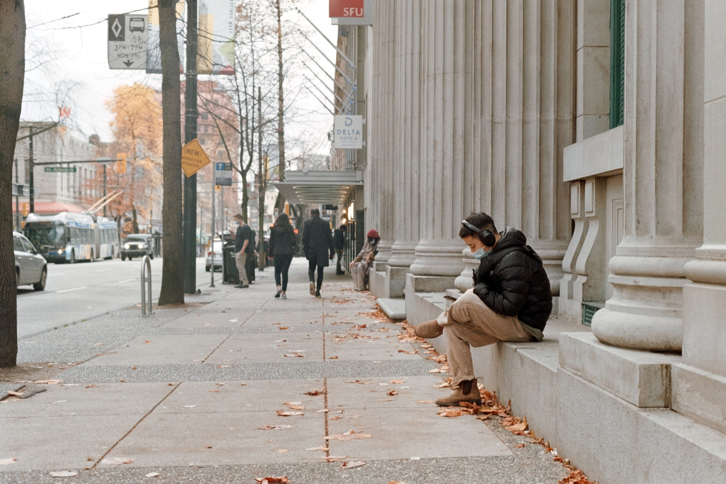 A young man rest on West Hastings in Vancovuer. Sample image from a Nikon EM and Kodak Gold 200
