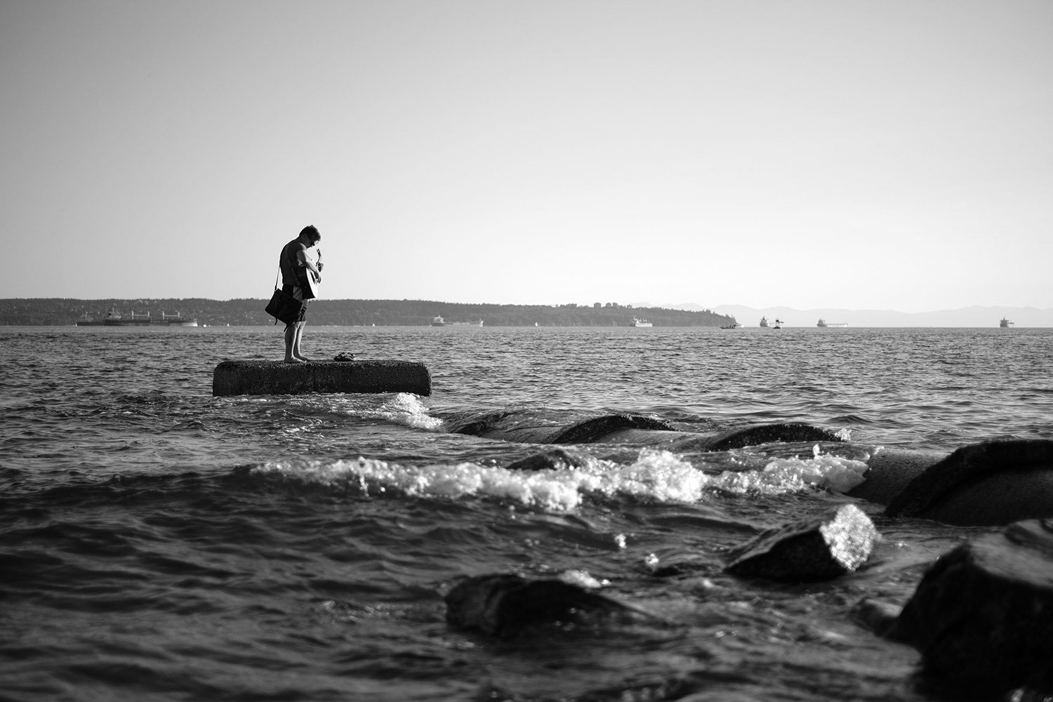 A guitar player making Ambleside Beach his stage