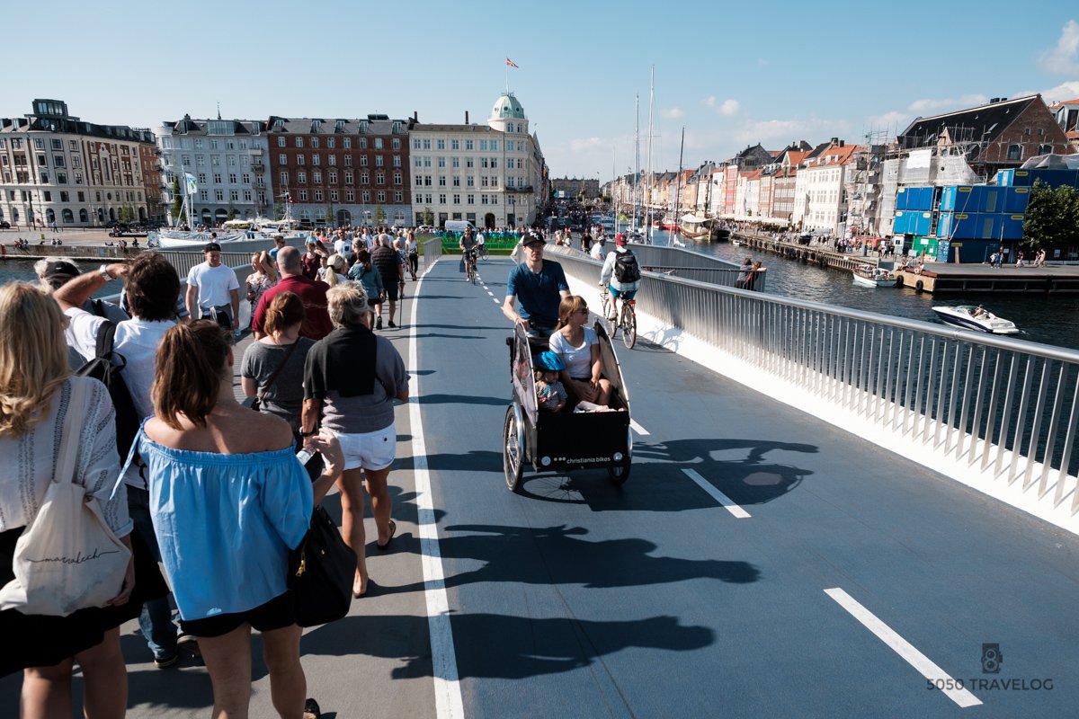 Family cycling across Inderhavnsbroen in Copenhagen