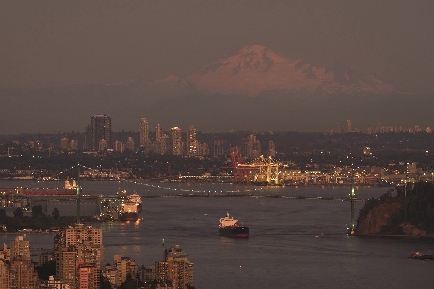 The Burrard Inlet, Lions Gate Bridge, and Mt. Baker in the background