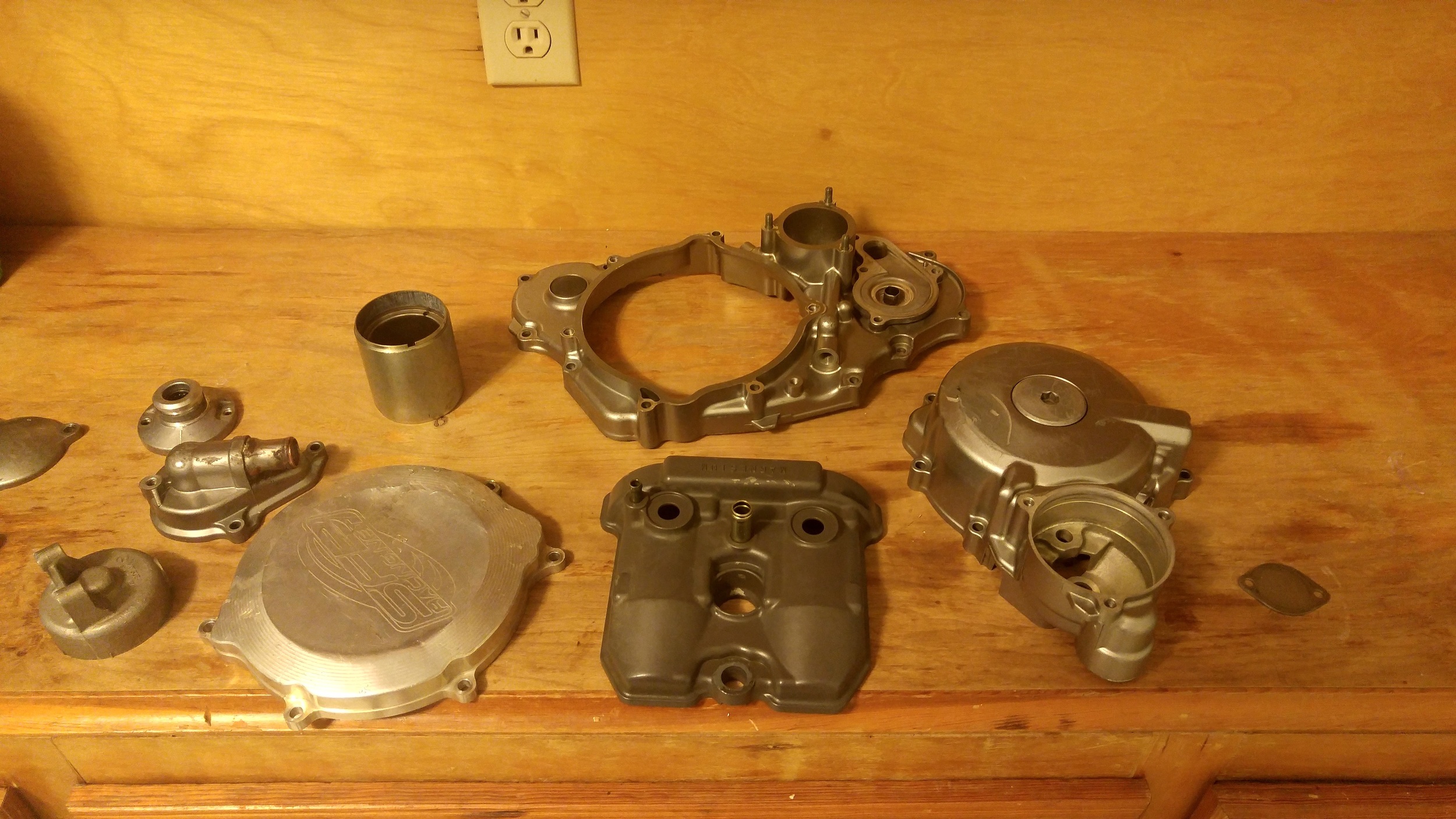Engine bits, including starter motor parts before powder coating. 