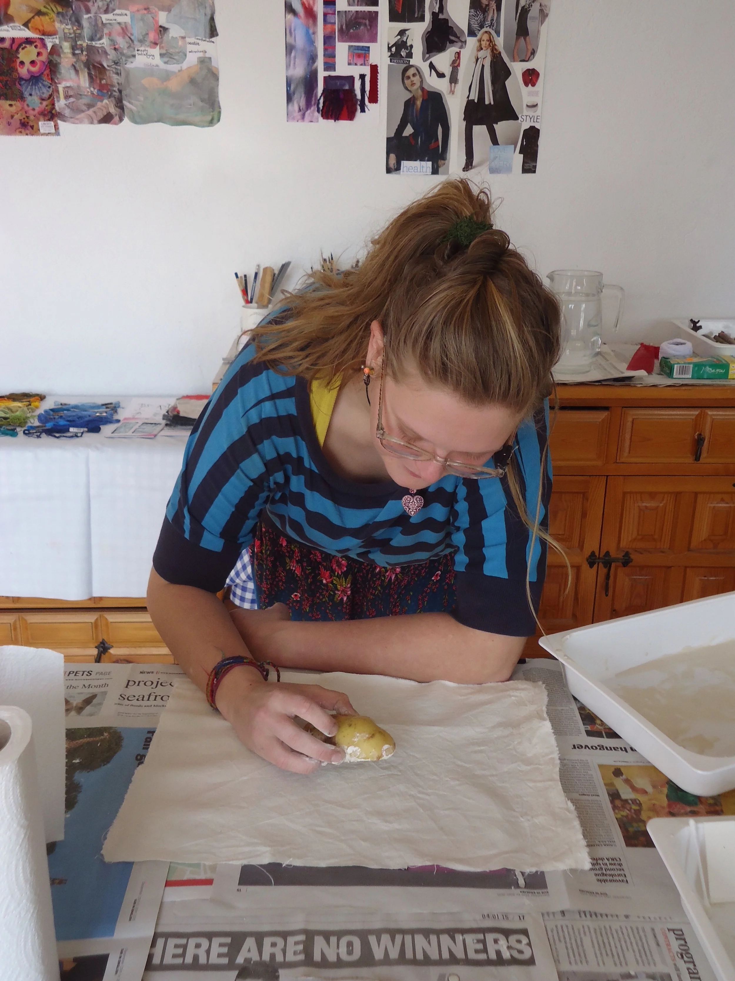 Applying the mud...using potato printing!