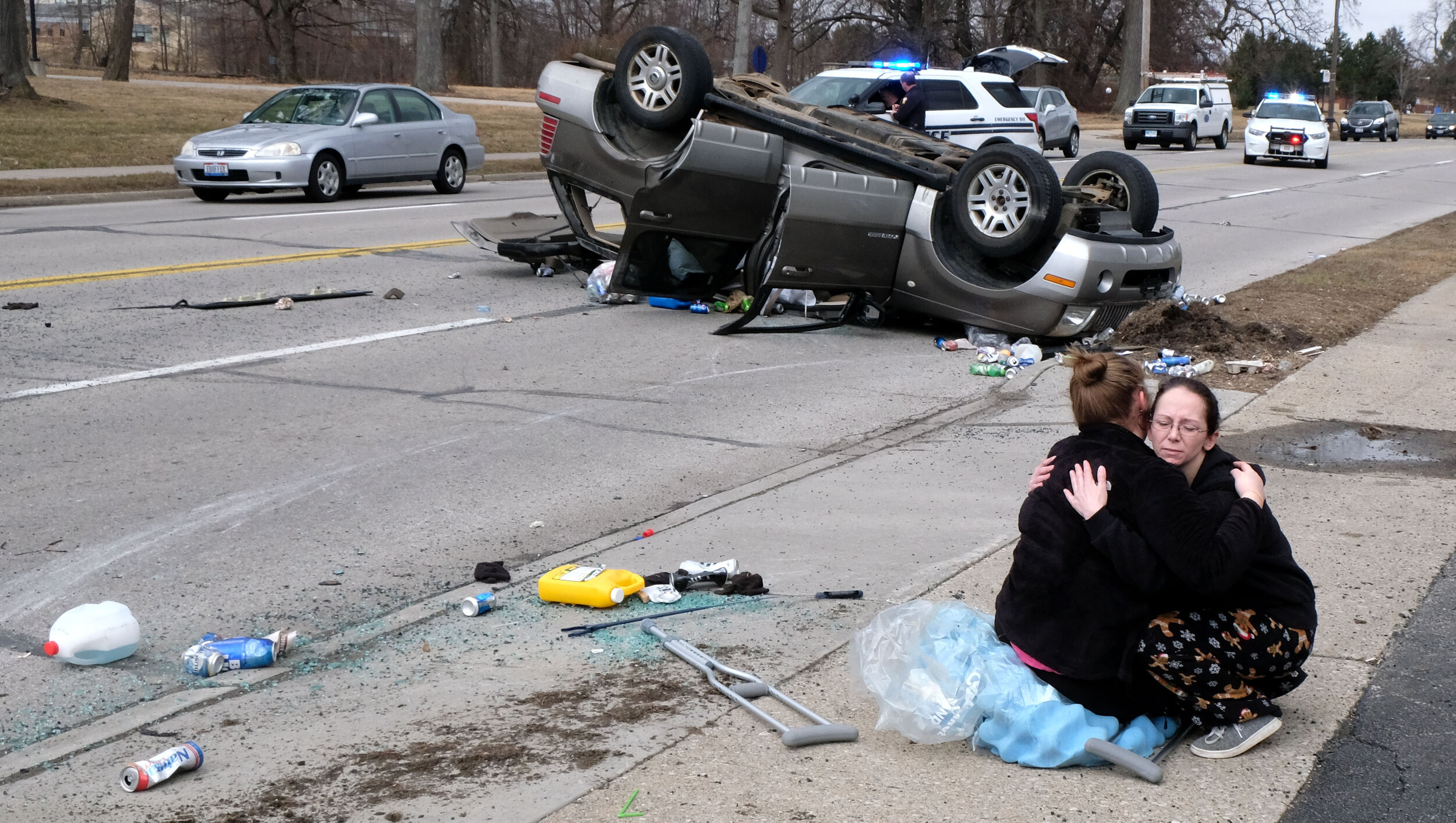  Ginger Bunting hugs her niece Madison Burleson, 15, after the vehicle Burleson was a passenger in was hit by another car and rolled several times on S. Detroit Ave. in Toledo. ©Toledo Blade 