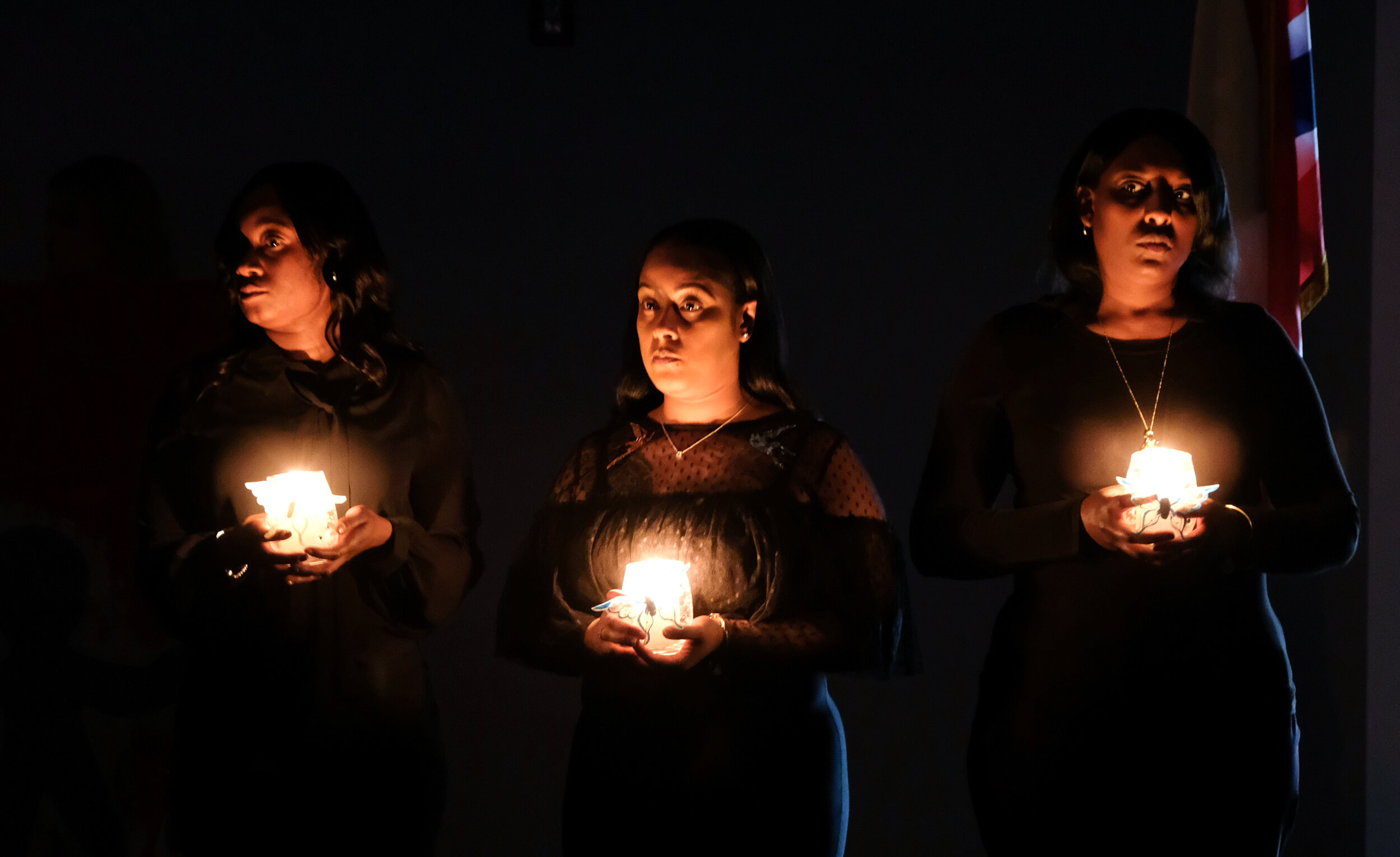  Case workers Dayna Riley, Crishanna Osley, Latoyia Johnson, hold candles representing three of the six children who were murdered in 2018. The ceremony was during the 2019 Child Memorial at Lucas County Children's Services. ©Toledo Blade 