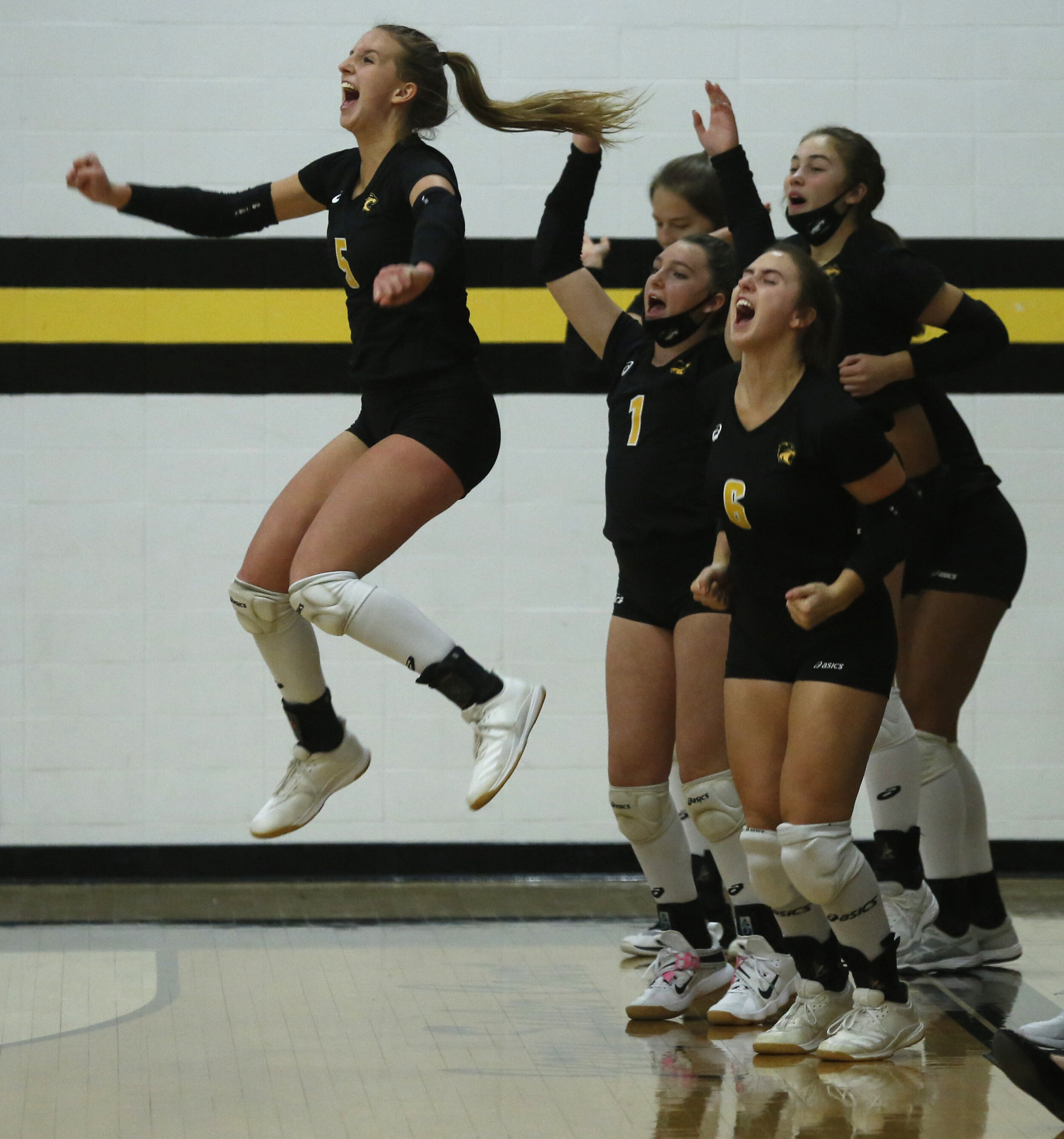  Northview’s Madi Taylor leaps in the air as she reacts to her team scoring against Perrysburg during the Div. 1 district volleyball final at Northview in Sylvania, Ohio. © Toledo Blade | October 2020 