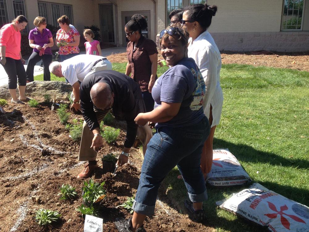  Staff &amp; supporters plant perennials in the Memorial Garden. 